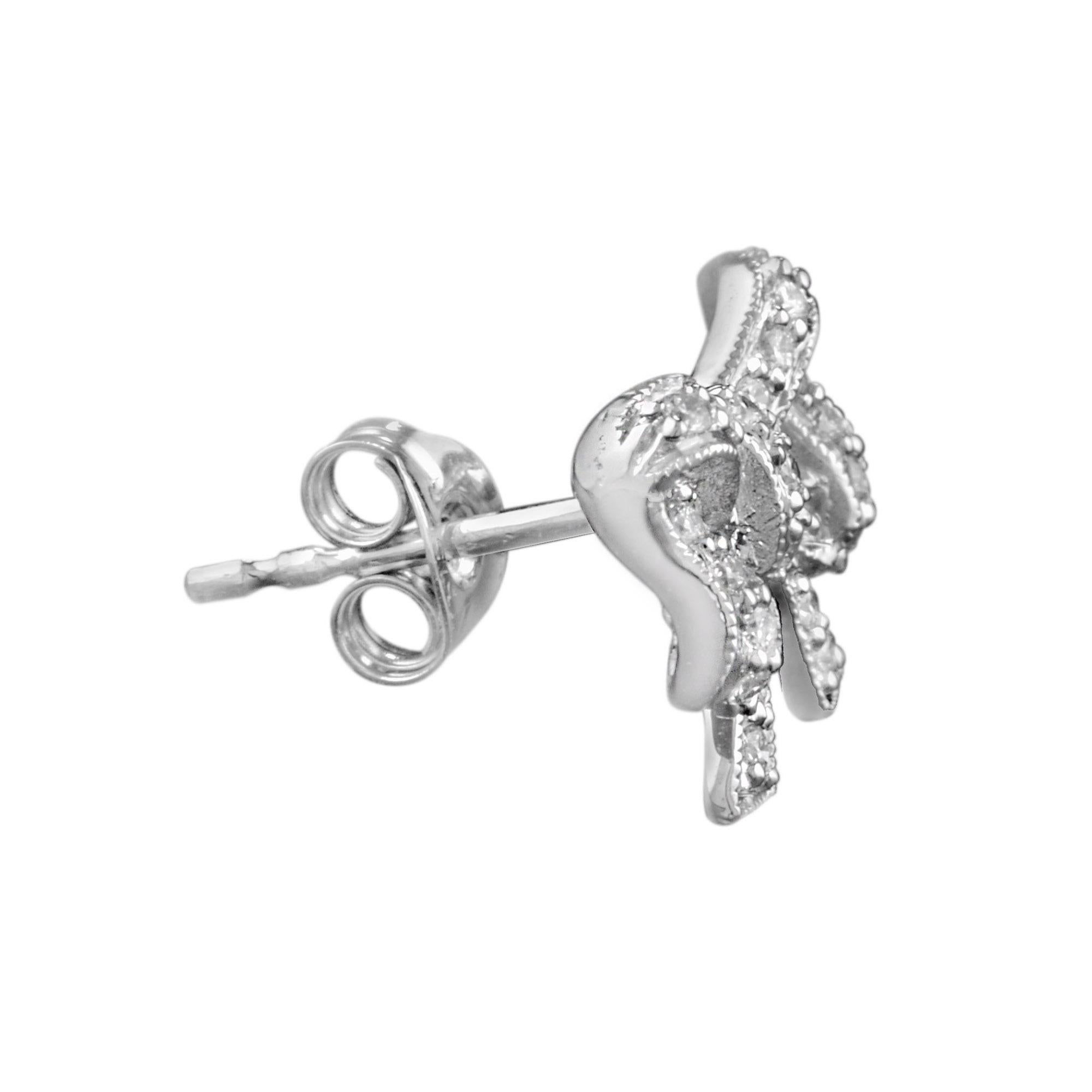 These lovely diamond bow earrings are the perfect feminine accessory. The studs are prong set with round brilliant cut diamonds. Total diamond weight approx. .40 carat. 14K White Gold. 
Earrings Information
Width: 11 mm.
Length: 15 mm.
Weight: 3.10