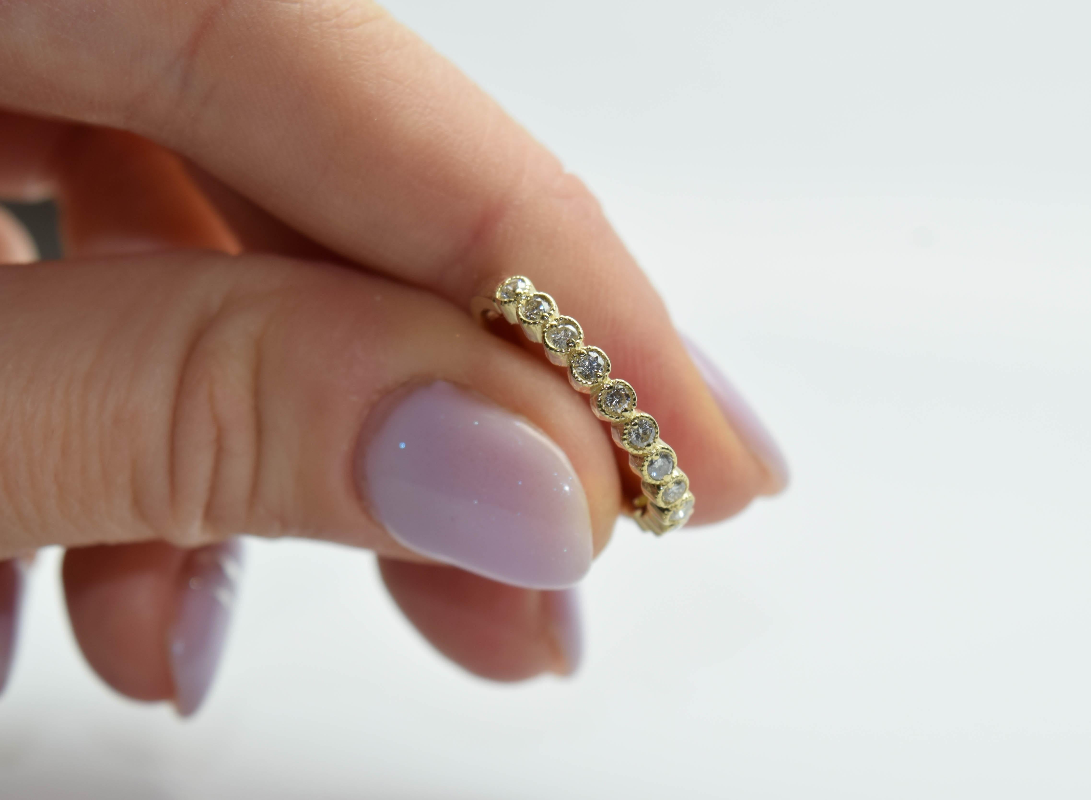 Beautiful simple diamond ring made with 12 diamonds in 14KT yellow gold, hand finished with tiny milgrain balls around each bezel which gives the ring a vintage feel and look.

Metal Type: 14KT
Natural Side Diamond(s):
Color: G-H
Cut:Round
