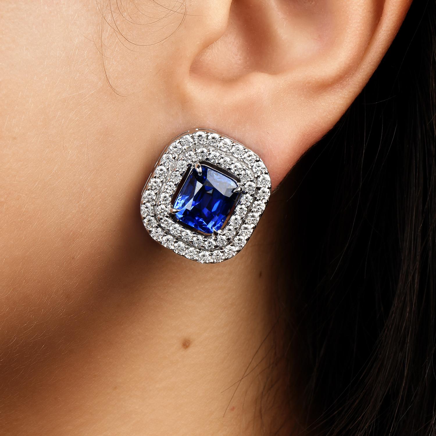 Royalty Blue in lovely double halo style elegant earrings.

They are crafted in solid 18K White Gold.

Each center has a Blue Sapphire, Cushion Cut, Heated,  prong Set, weighing collectively approx: 8.69 carats.

The double halo has