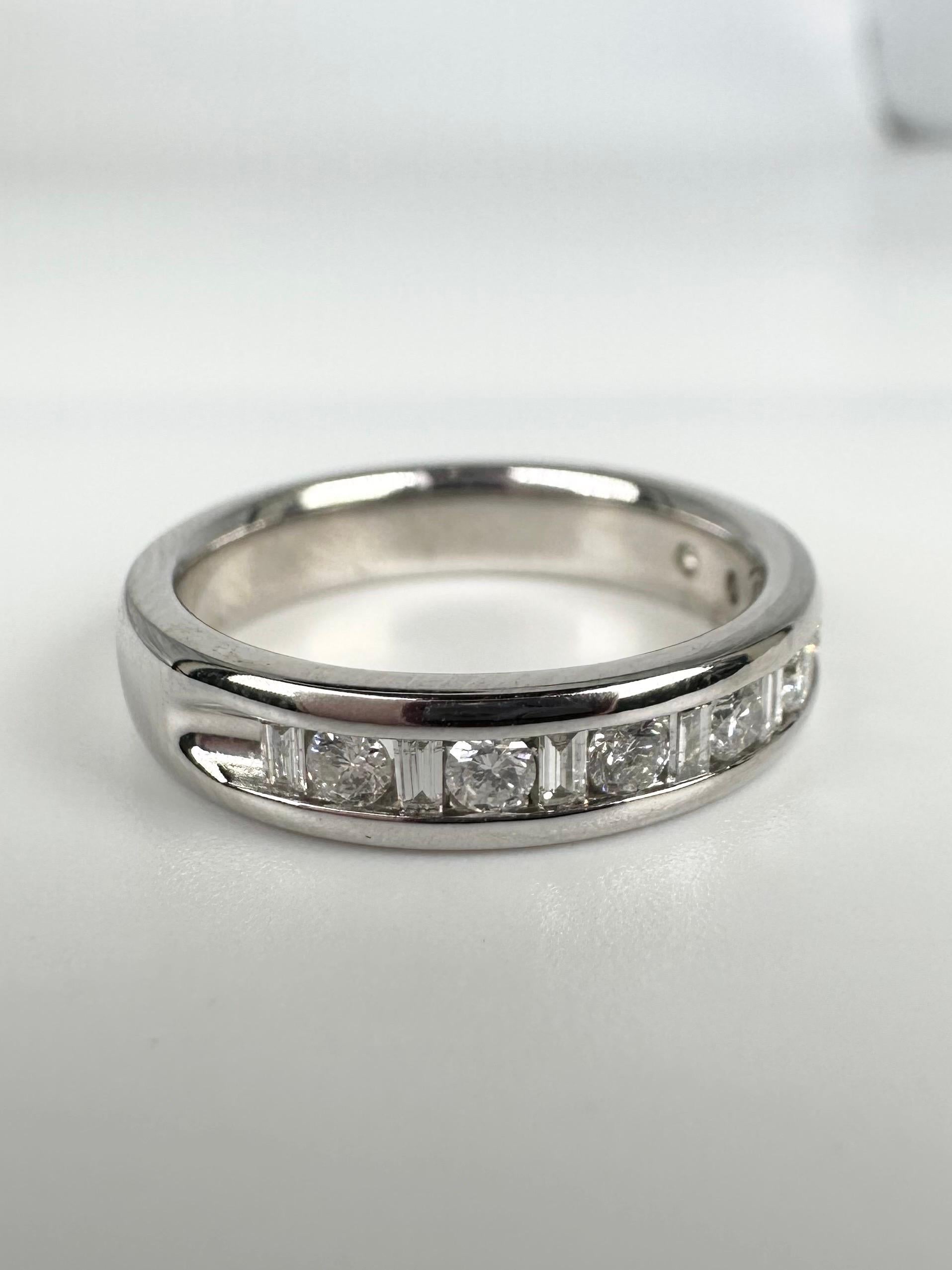 Simple wedding band with round brilliants and baguettes in channel setting made in 14KT white gold.

GOLD: 14KT gold
NATURAL DIAMOND(S)
Clarity/Color: VS-SI/G
Carat:0.46ct
Cut:Baguette, Round Brilliant
Grams:5.11
size: 6
Item#: 110-00031AKO

WHAT