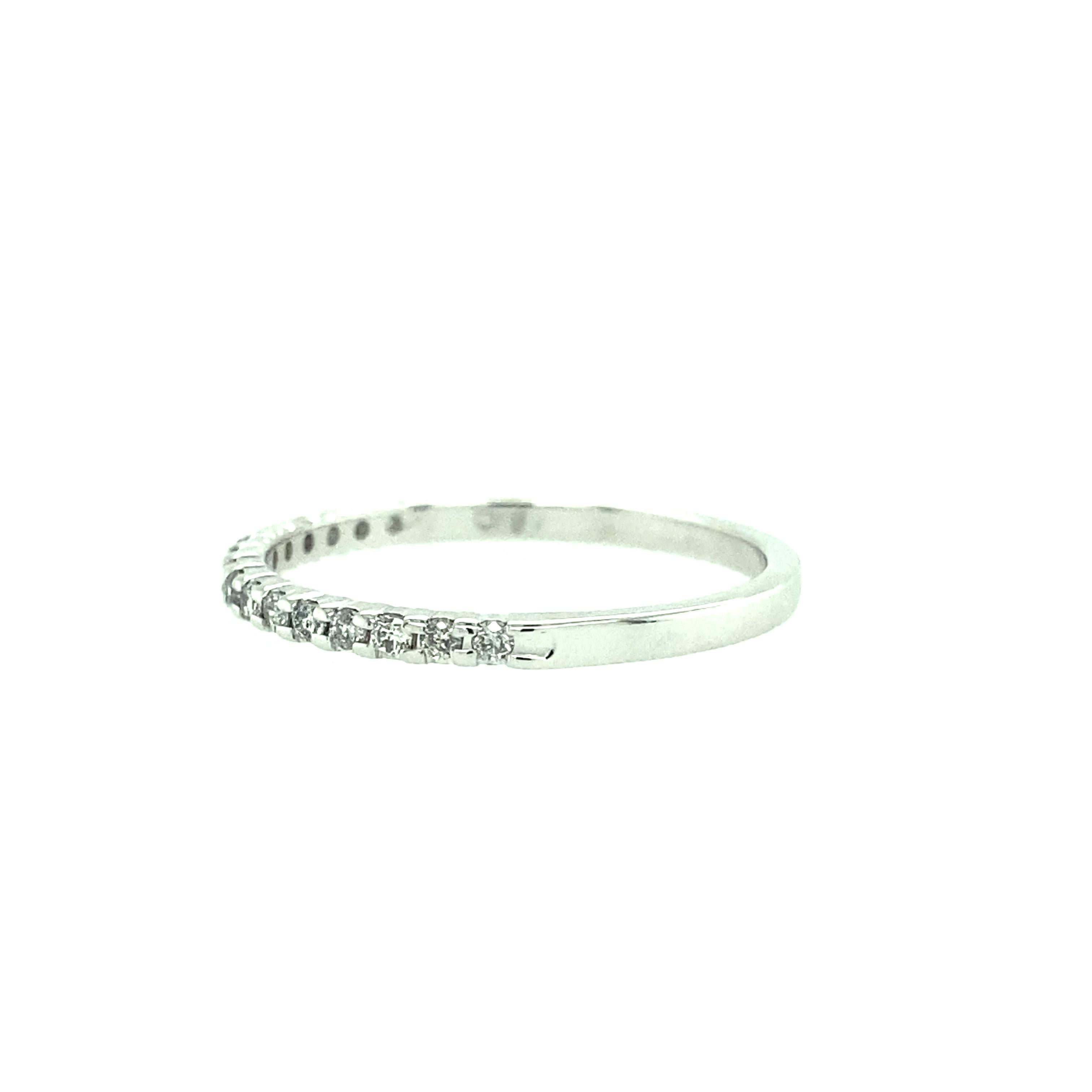 One 10 karat white gold (stamped 10K HDO) diamond wedding band set with sixteen round brilliant diamonds, 0.10 carat total weight with matching H/I color and I clarity. The band measures 1.60mm wide and is a finger size 7.