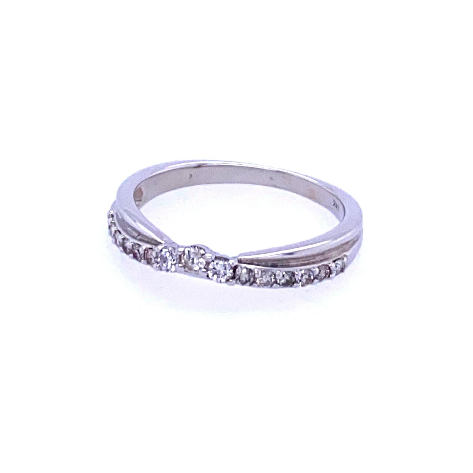 14 karat white gold (stamped 14K) band with 15 round brilliant diamonds in the I/J color range,  SI clarity, and 0.20 carat total weight. The ring features a twisted double row, and measures 3.2 mm at the top then tapers to 1.75 mm at the base. The