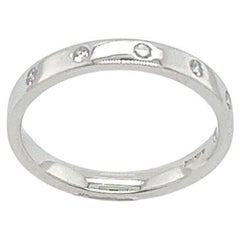 Alianza de 6 diamantes 0,06 ct en oro blanco de 18 ct