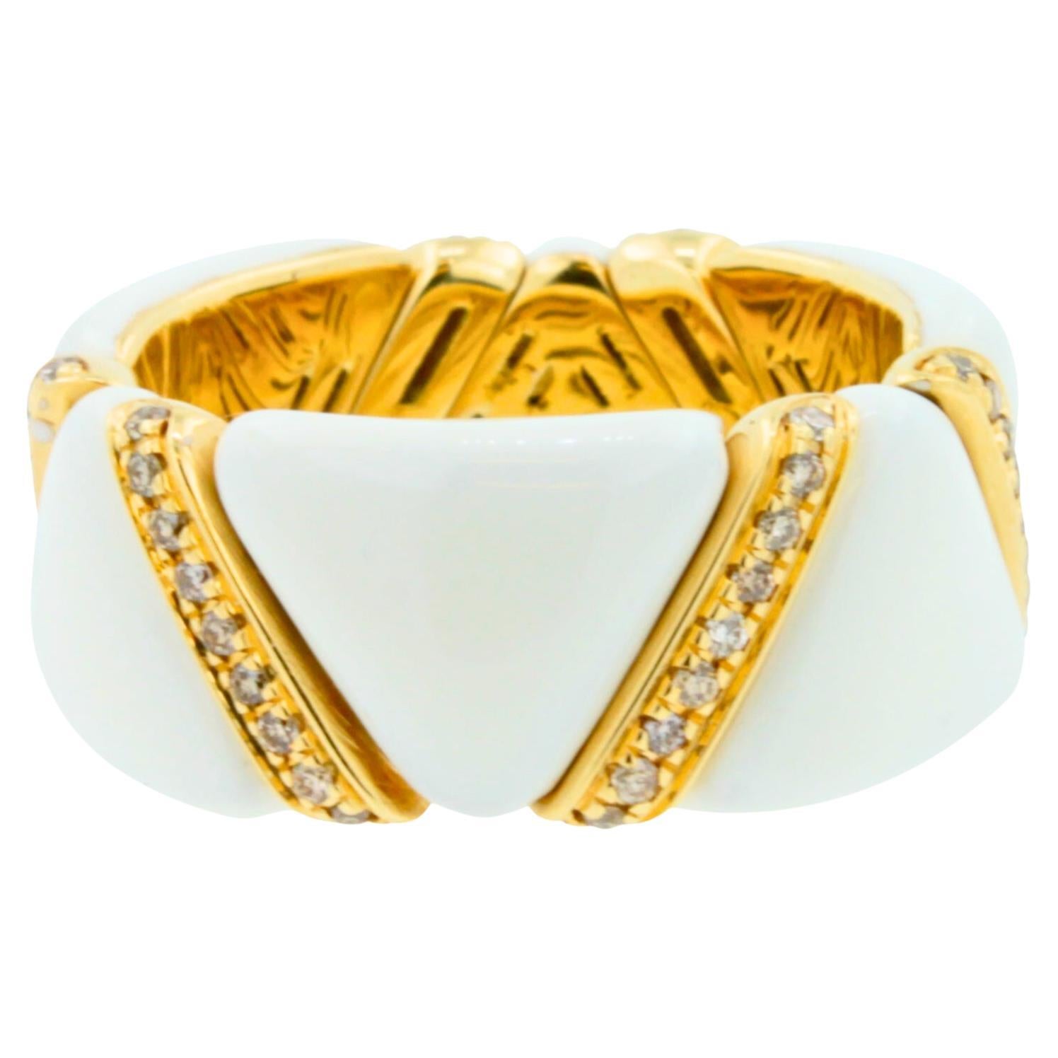 Mixing an art deco aesthetic with contemporary flair, the hand-made rings in pink, white and yellow 18k gold are versatile and feature a unique stretch mechanism. Capturing the fascinating tradition of enameling, the Ez Glaze rings shimmer in serene