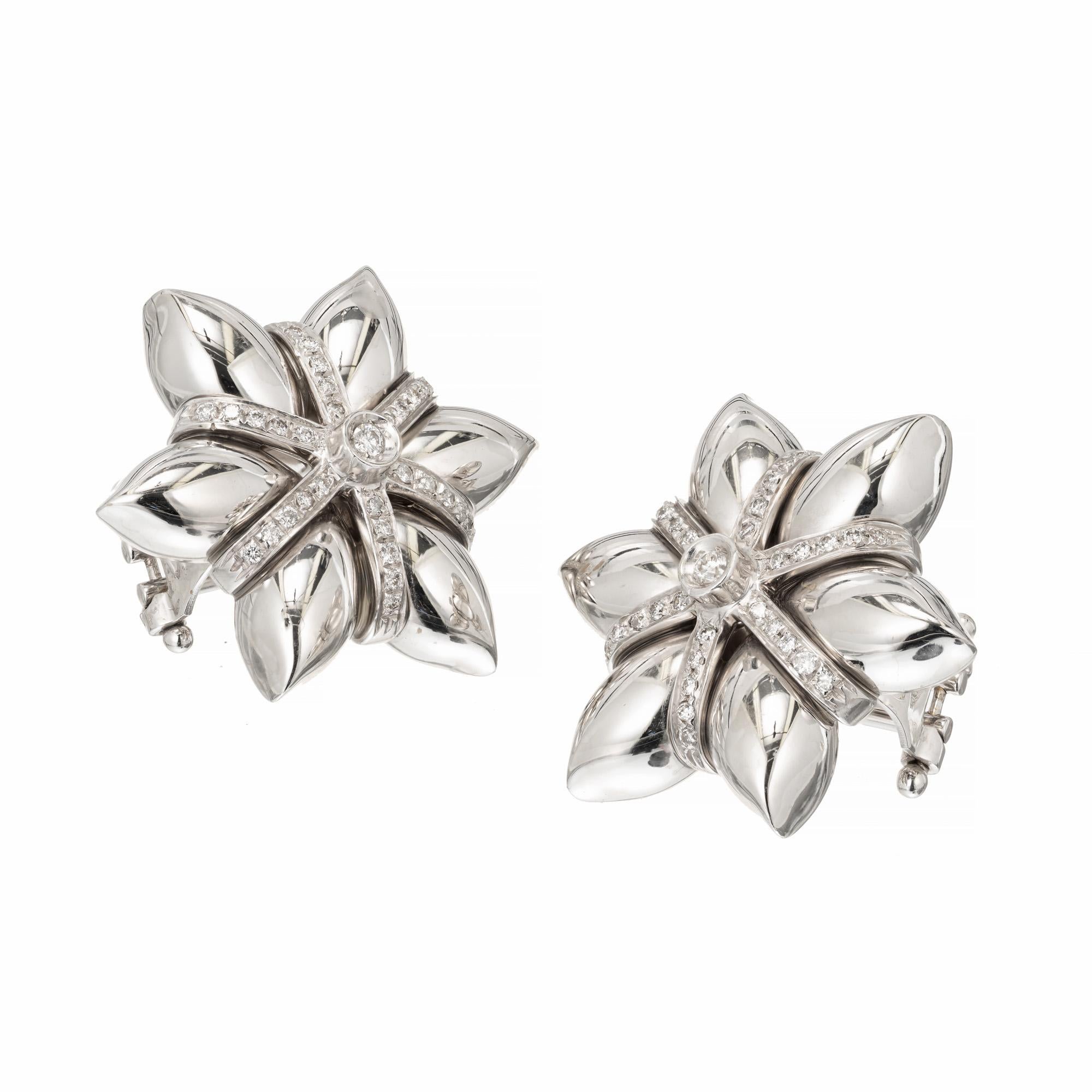 3 dimensional diamond 18k white gold star shaped earrings. Full cut Diamond bead set stripes. Lever backs. 

62 round diamonds approx. total weight .36cts
18k White Gold
Stamped 750 18k
13.4 grams
7 x 1 inch