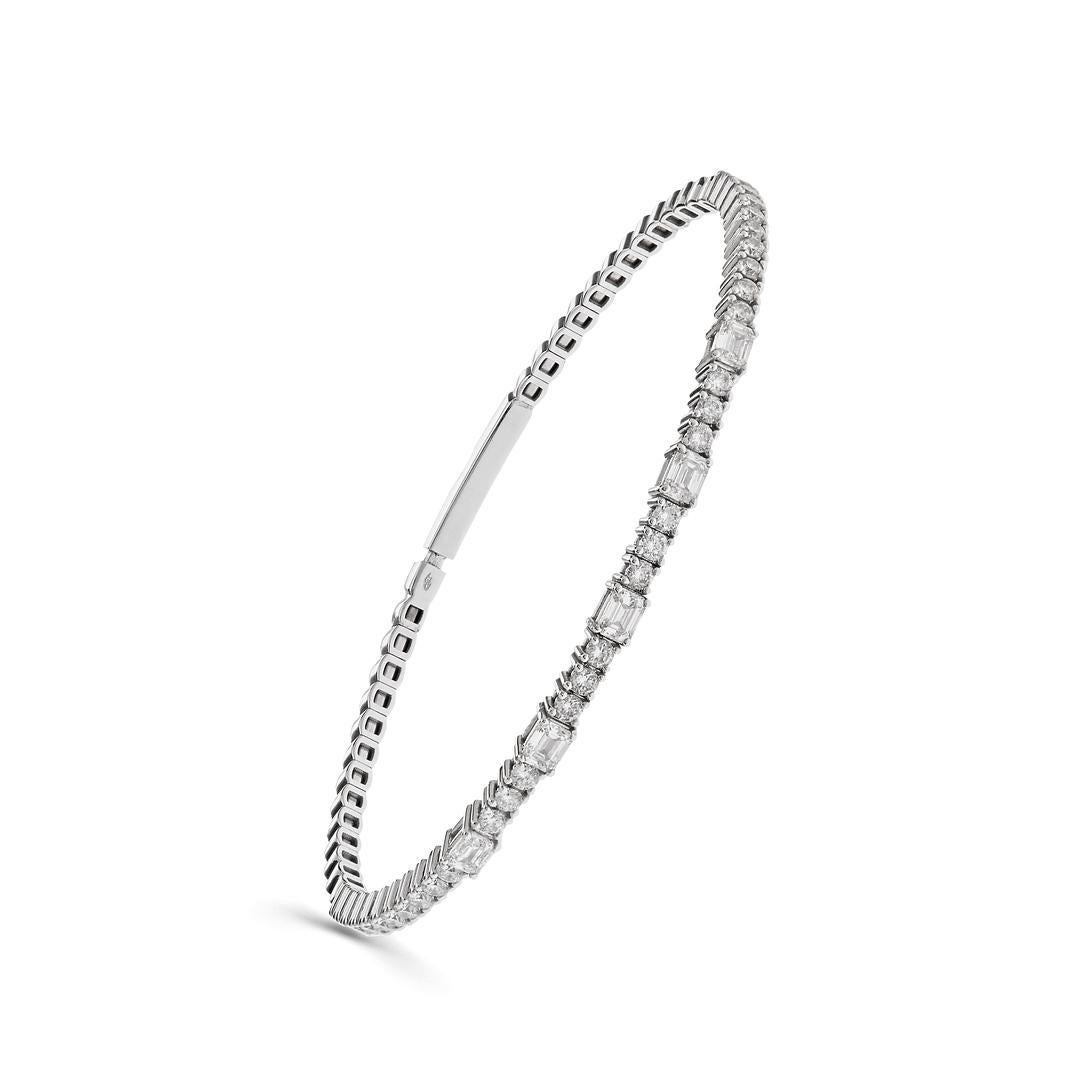 Indulge in the sheer opulence and timeless elegance of the White Gold Diamond Alternating Bangle, a stunning testament to luxurious sophistication and impeccable craftsmanship.

Crafted from luminous white gold, this exquisite bangle features a