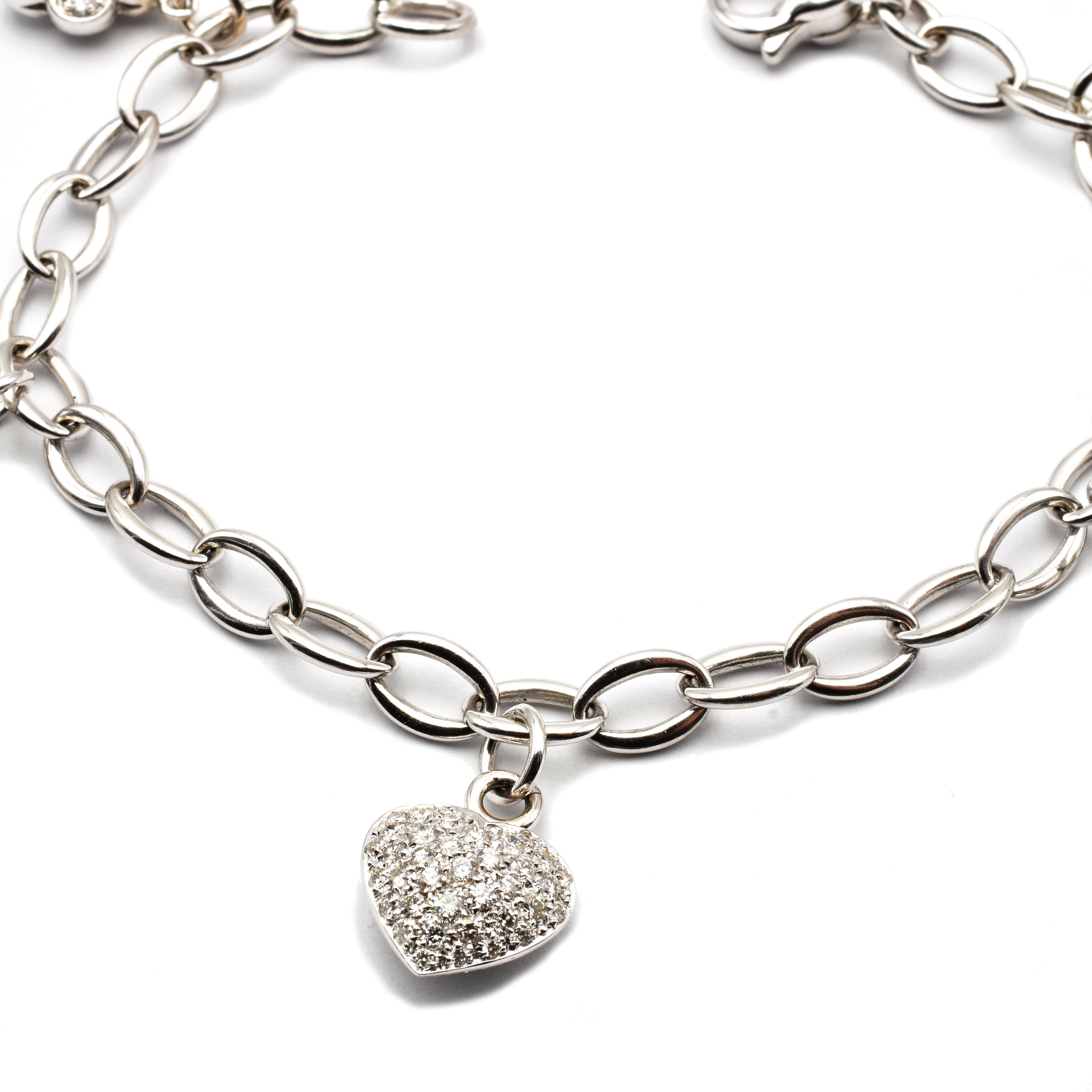 18 Kt White Gold Bracelet with Mixed Hanging Charms in White Diamonds. 
One Heart, One Star, One Half Moon and two Flowers.
Handmade in Italy in our Atelier in Valenza (AL).
18Kt Gold g 19.40
White Diamonds (G Color Vs Clarity) ct 2.63
All Charms