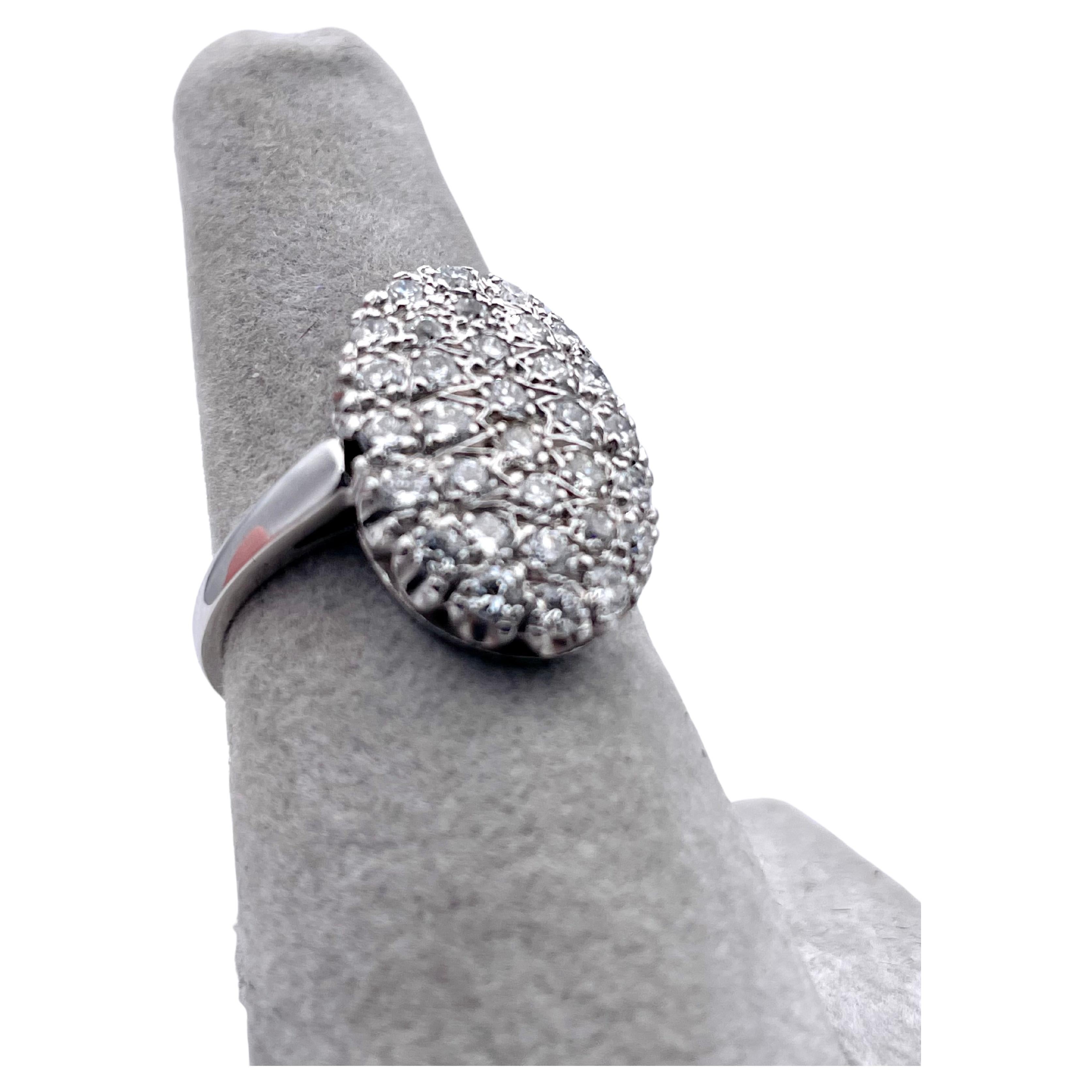 Large oval cocktail ring.  Well-matched and well-selected near colorless diamonds.  Round brilliant cut, weighting approximately 1.80 carats.  Set in 14K white gold. 3/4
