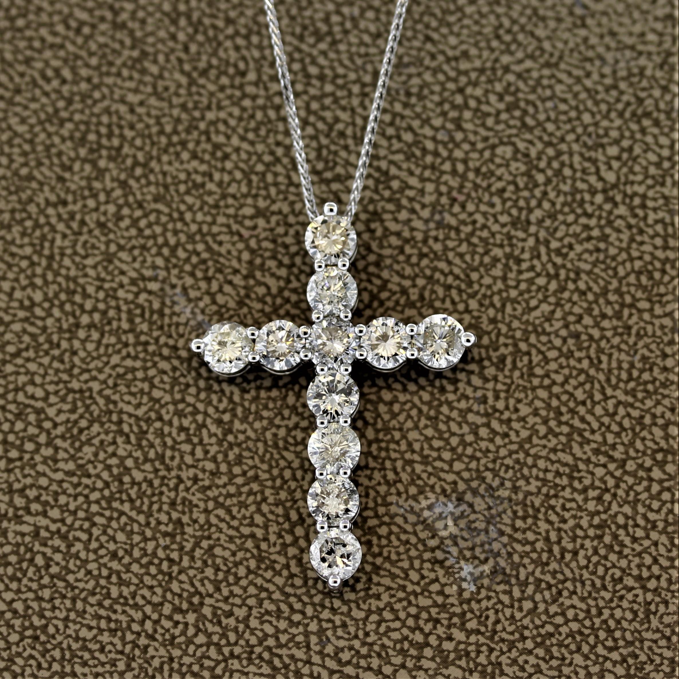 A classic cross necklace featuring larger than normal diamonds. There are 11 round brilliant cut diamonds weighing a total of 3.60 carats. Set safely into 14k white gold and comes with a matching white gold necklace.

Cross Length: 1.25