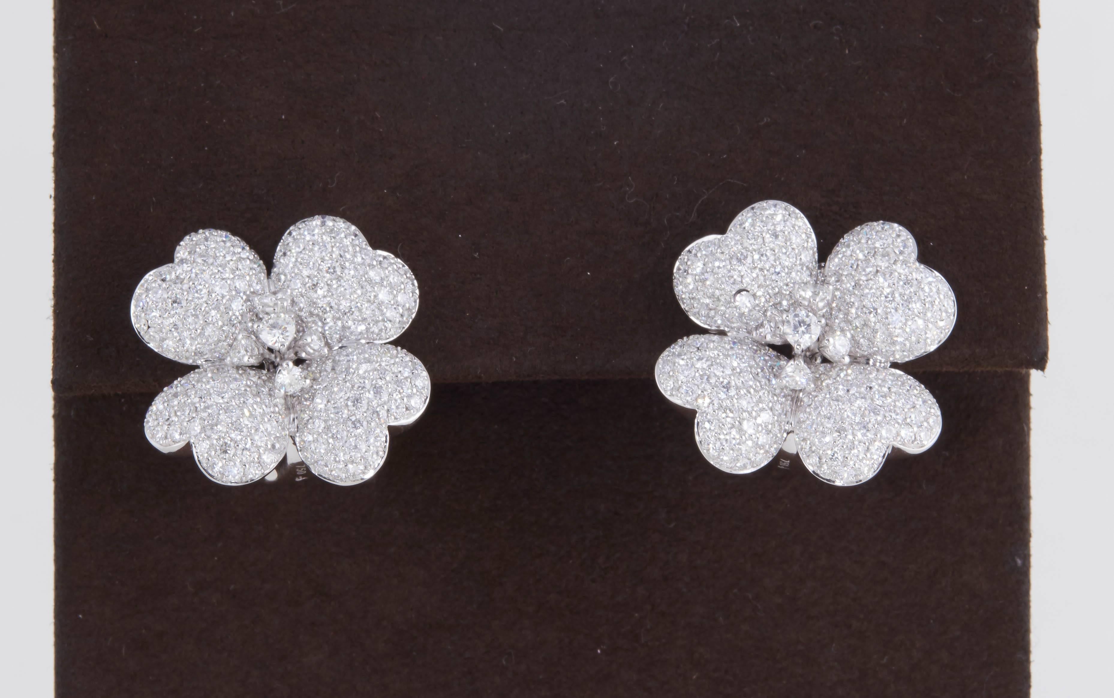 
A fabulous pair of diamond flower earrings. 

Tons of sparkle set on 4 delicately designed flower petals. 

4.16 carats of high quality F color VS clarity round brilliant cut diamonds set in 18k white gold.

Approximately .78 inches in diameter.