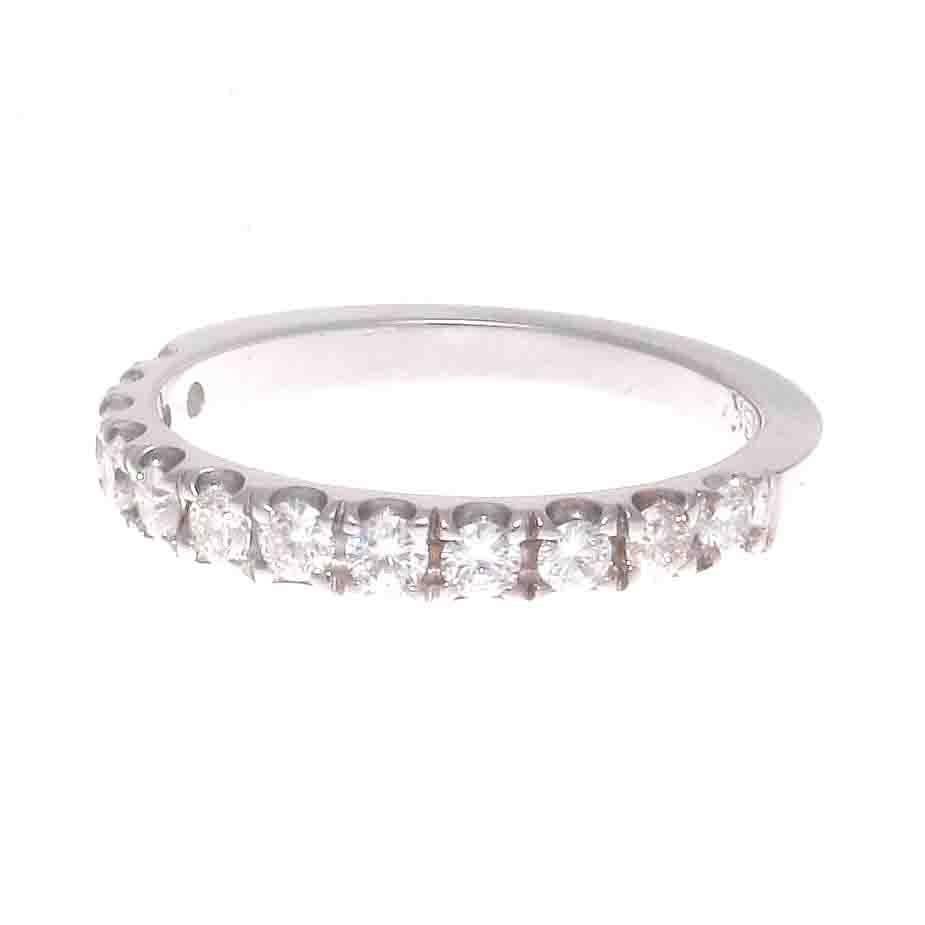 A timeless elegance radiates from this diamond gold wedding band that is ready to be paired with any engagement ring. Featuring twelve perfectly matching white, clean round cut diamonds weighing approximately 0.60 carats, expertly set in this