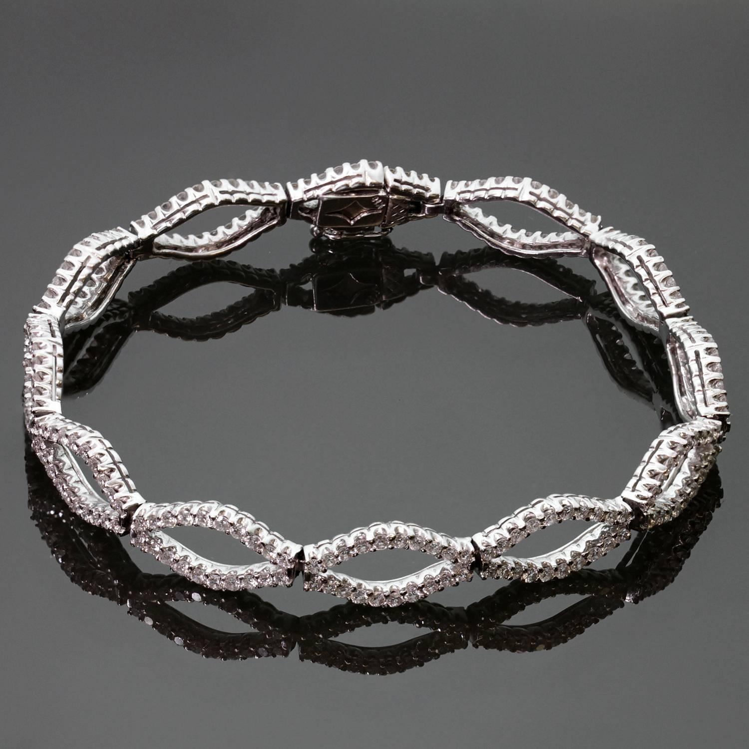This stunning women's tennis bracelet features marquise-shaped links made in 18k white gold and set with 240 sparkling round diamonds. An elegant design. Measurements: 0.31