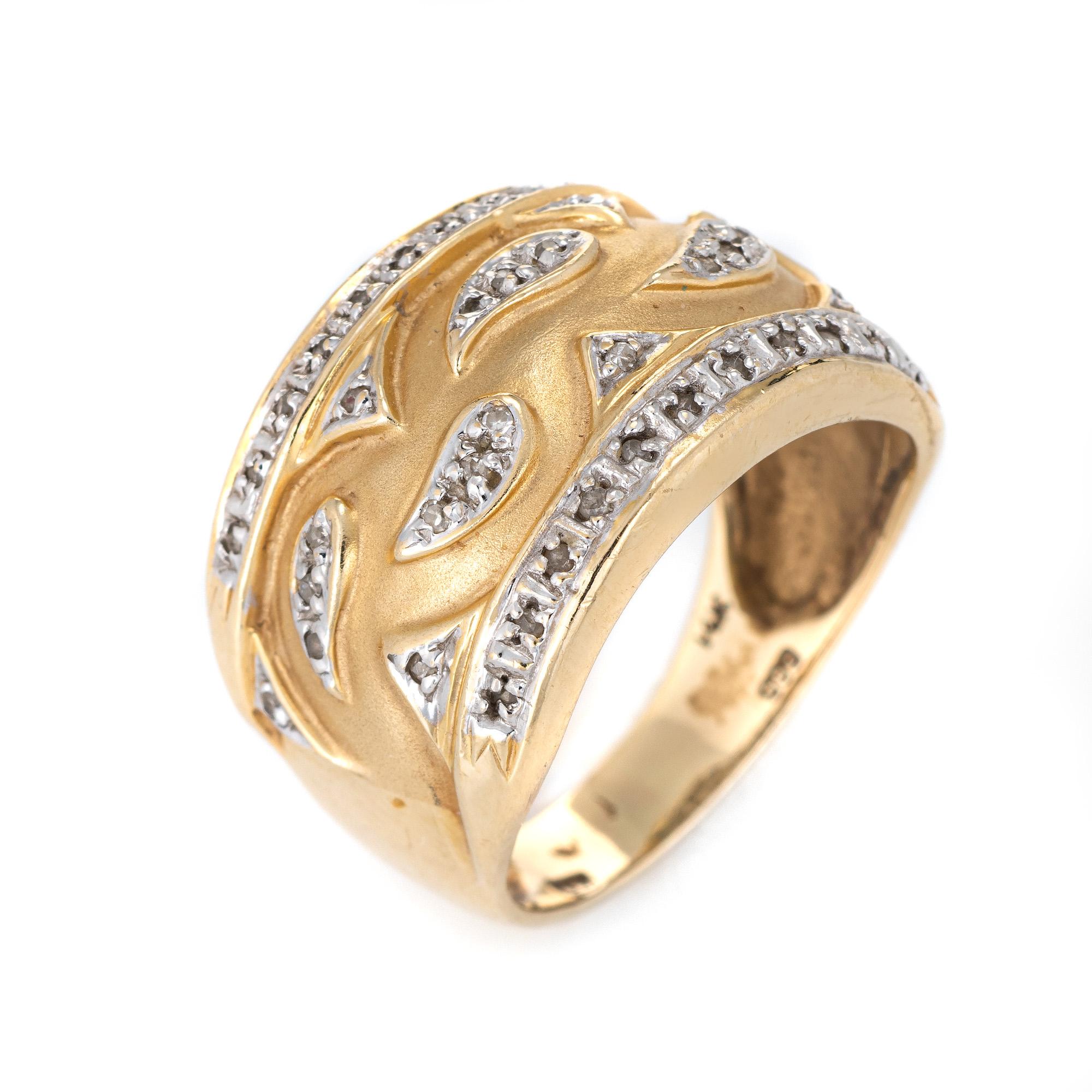 Stylish vintage wide band cigar band crafted in 14 karat yellow gold. 

Diamonds total an estimated 0.20 carats (estimated at I-J color and I1-2 clarity).  

The diamonds are set into a wave like design against a muted gold backdrop. The wide band