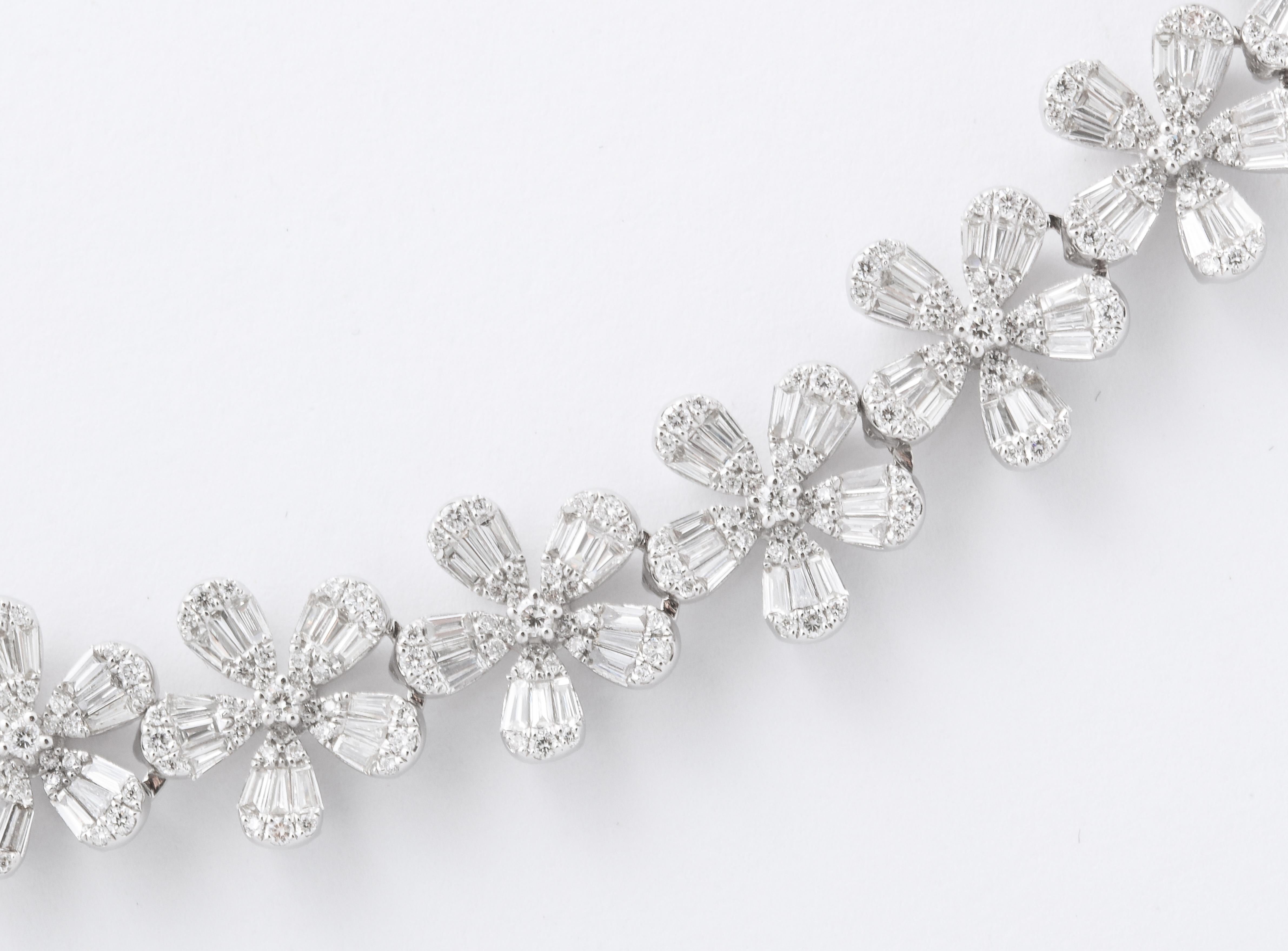 
A classic wreath necklace, full of sparkle!

14.54 carats of white round brilliant cut and baguette cut diamonds set in flower shapes. 

18k white gold

.45 inches wide -- 17 inch length

A fantastic looking piece!