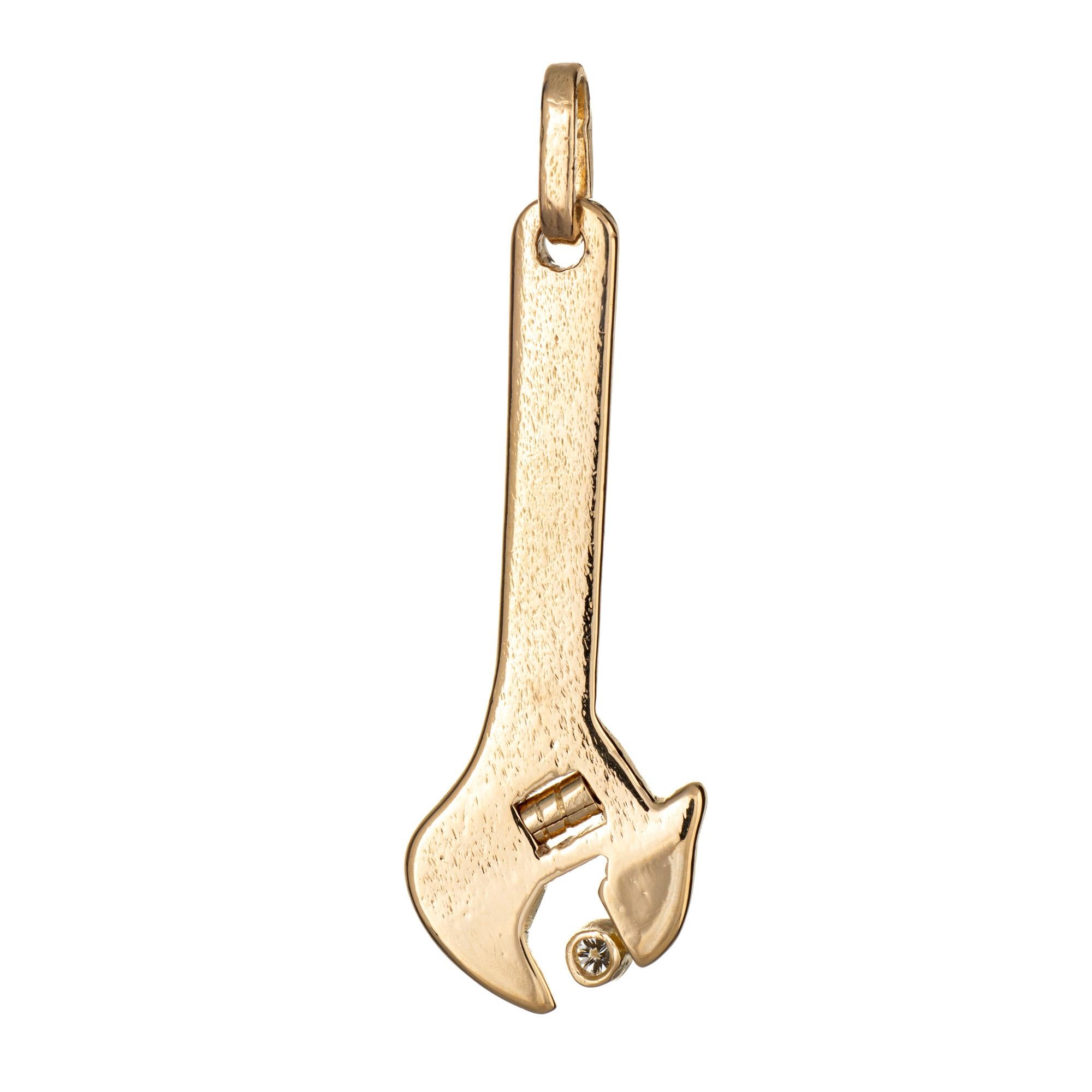 Finely detailed vintage diamond wrench pendant or charm crafted in 14k yellow gold.  

Round brilliant cut diamond is estimated at 0.04 carats (estimated at G-H color and VS clarity). 

The wrench features lifelike detail with a diamond set to the