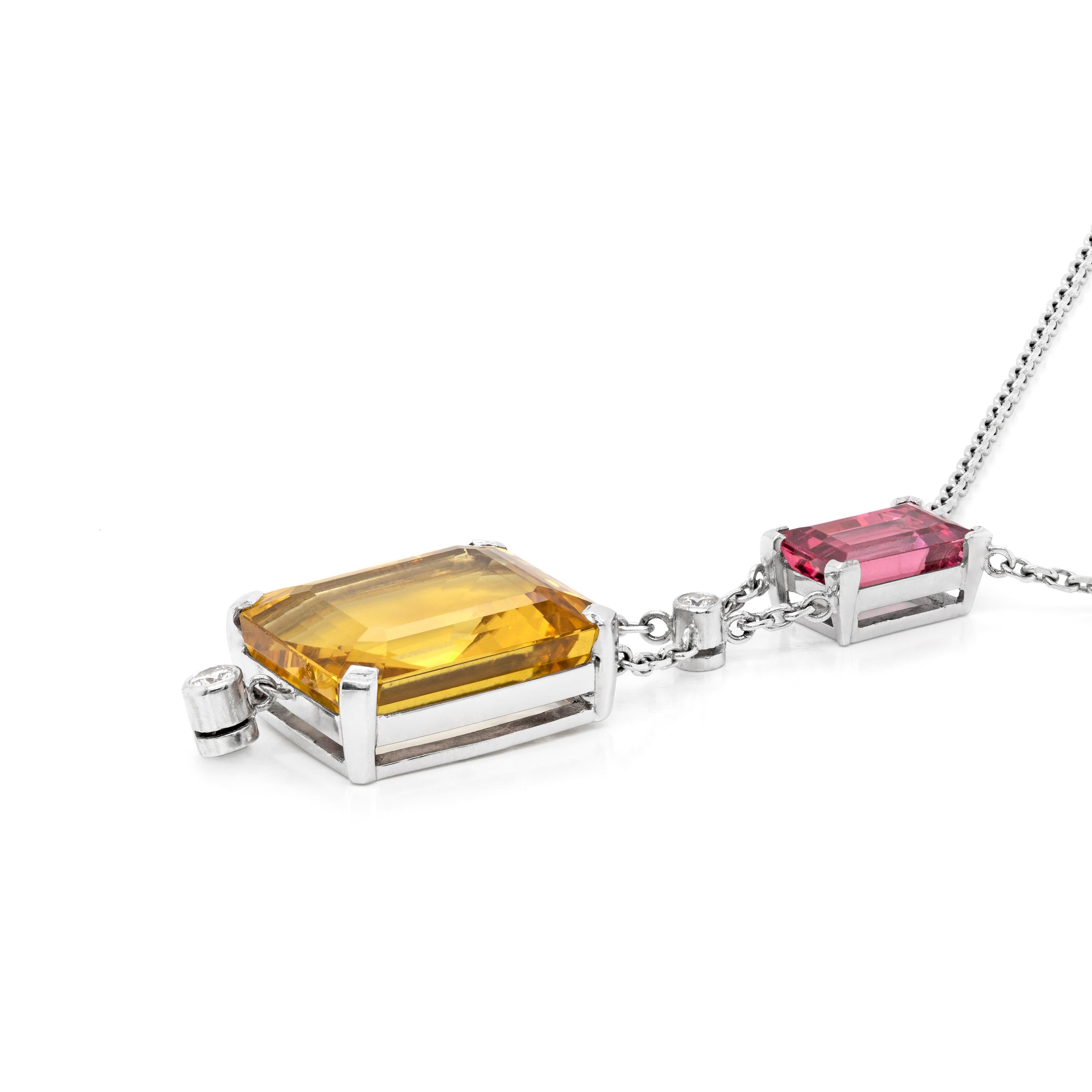 This stunning drop pendant necklace features an emerald cut pink spinel weighing 3.40ct set in a four claw, open back setting. Hanging below suspends a rubover set round brilliant cut diamond weighing 0.07ct holding an impressive 16.78ct emerald cut