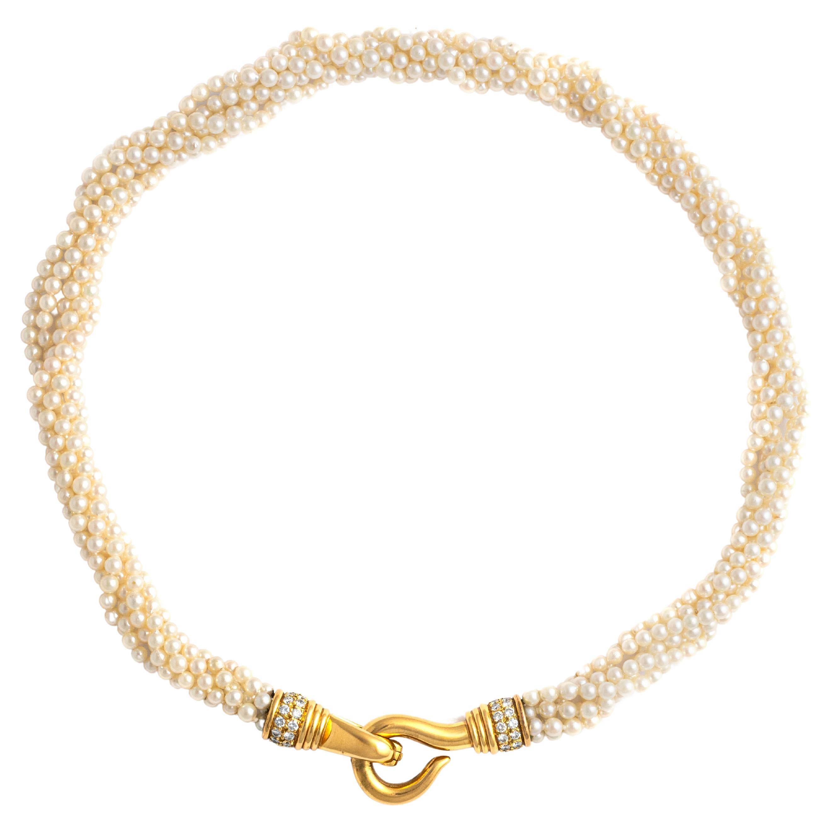 Cultured Pearl Necklace (6 strands of pearls) holding a Diamond Yellow Gold 18K clasp, set by 52 round cut diamonds H color and VS clarity. 
This statement piece boasts six strands of luminous cultured pearls, meticulously arranged to create a