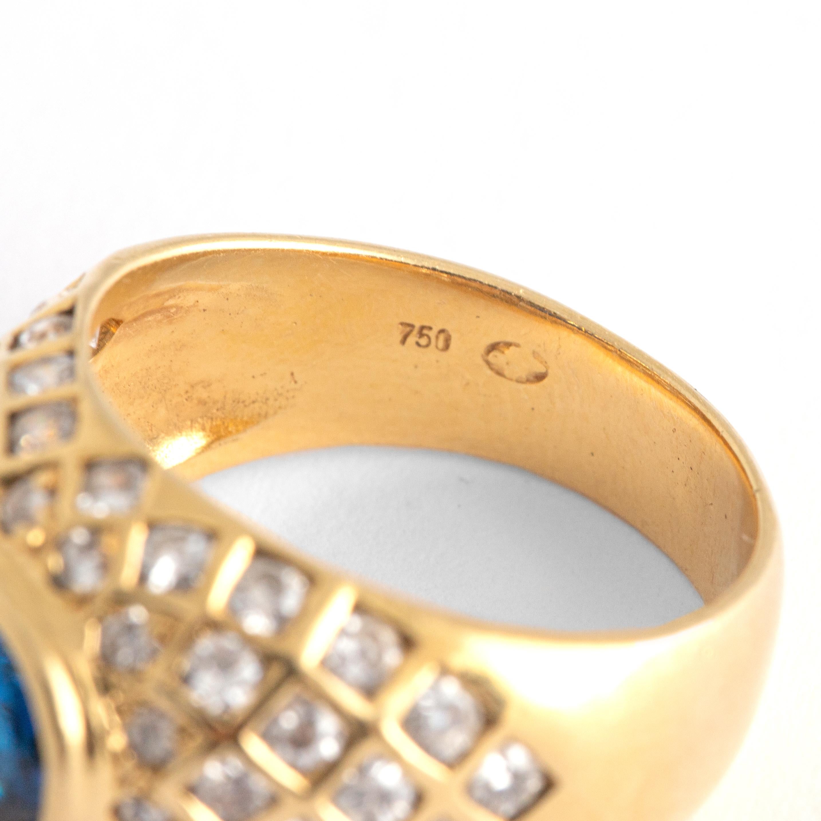 Diamond Yellow Gold 18K Ring centered by a blue stone not tested. Probably synthetic Sapphire.
Size: 54
Total weight: 8.65 grams.
