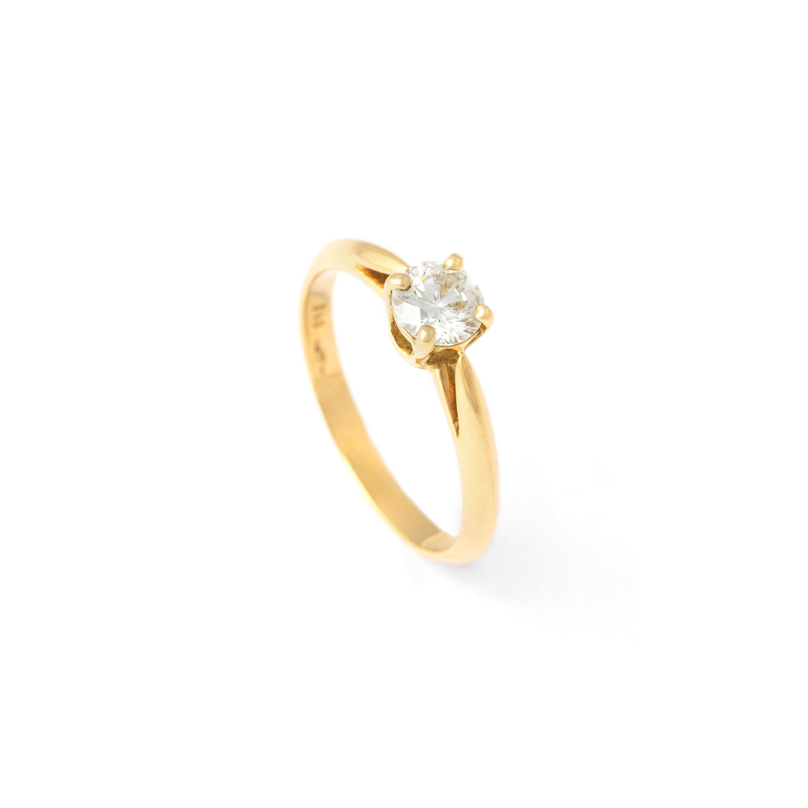 Embrace timeless sophistication with our Diamond Yellow Gold 18K Ring, featuring a captivating centerpiece - a round-cut diamond weighing approximately 0.51 carats, with an estimated G color and VVS2 clarity. Set in the warmth of 18K yellow gold,