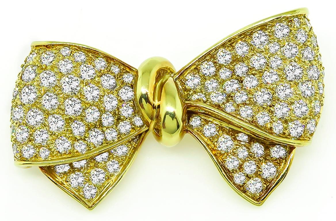 This magnificent 18k yellow gold bow pin is set with sparkling round cut diamonds that weigh approximately 5.00ct. graded F-G color with VS clarity. The pin measures 27mm by 42mm and weighs 15.6 grams. It is stamped 18k.



Inventory #58167AABS