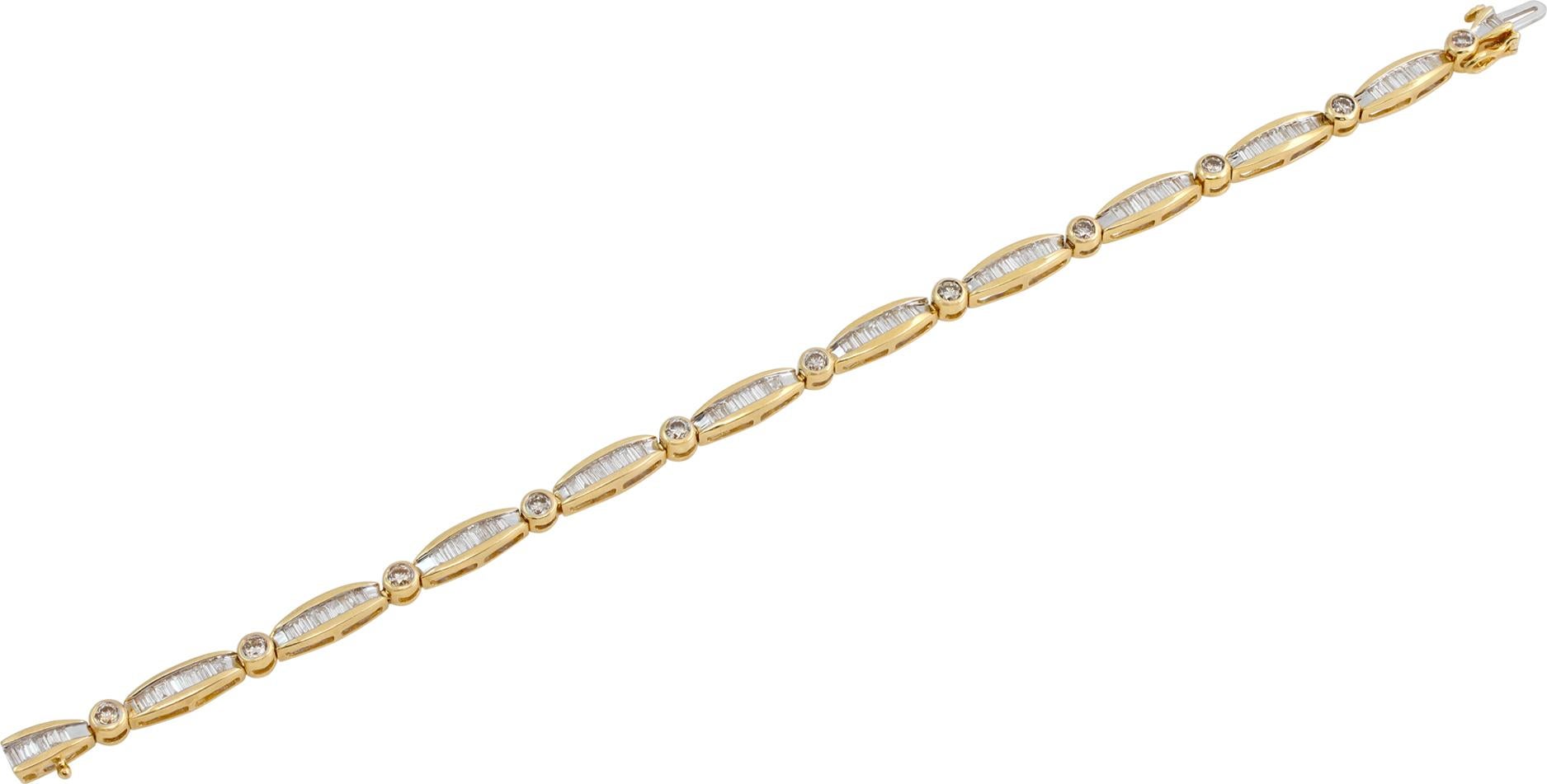 Diamond bracelet in 14k yellow gold with over 1.50 cararts in round and baguette G-H color, VS-SI clarity diamonds. Length 7 inches.