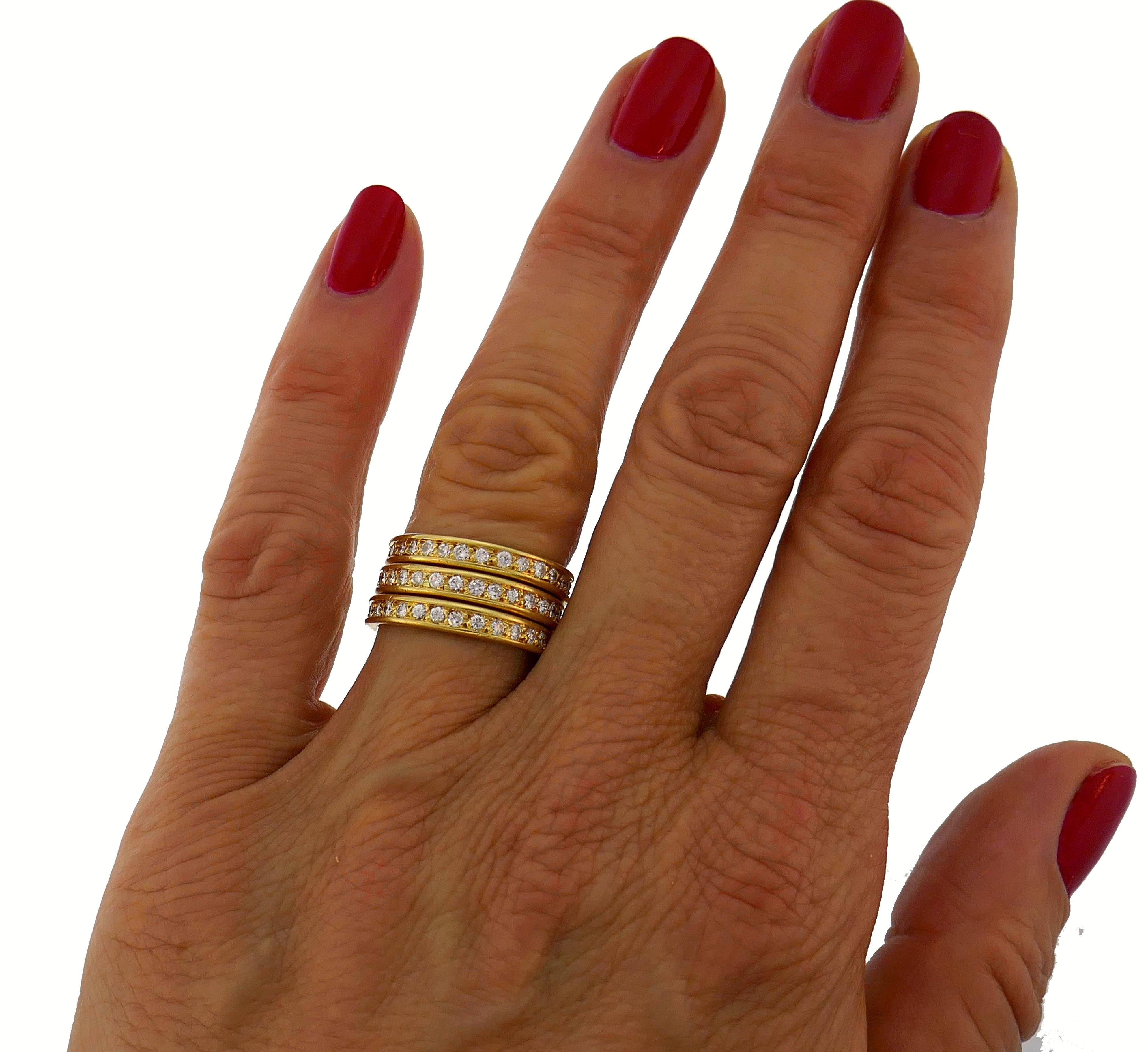 A trio of classy and timeless eternity bands created in France in the 1970s. 
They are made of 18 karat yellow gold and each is set with twenty nine round brilliant cut diamonds (G-H color, VS clarity, total weight approximately 1.30 carats). 
The