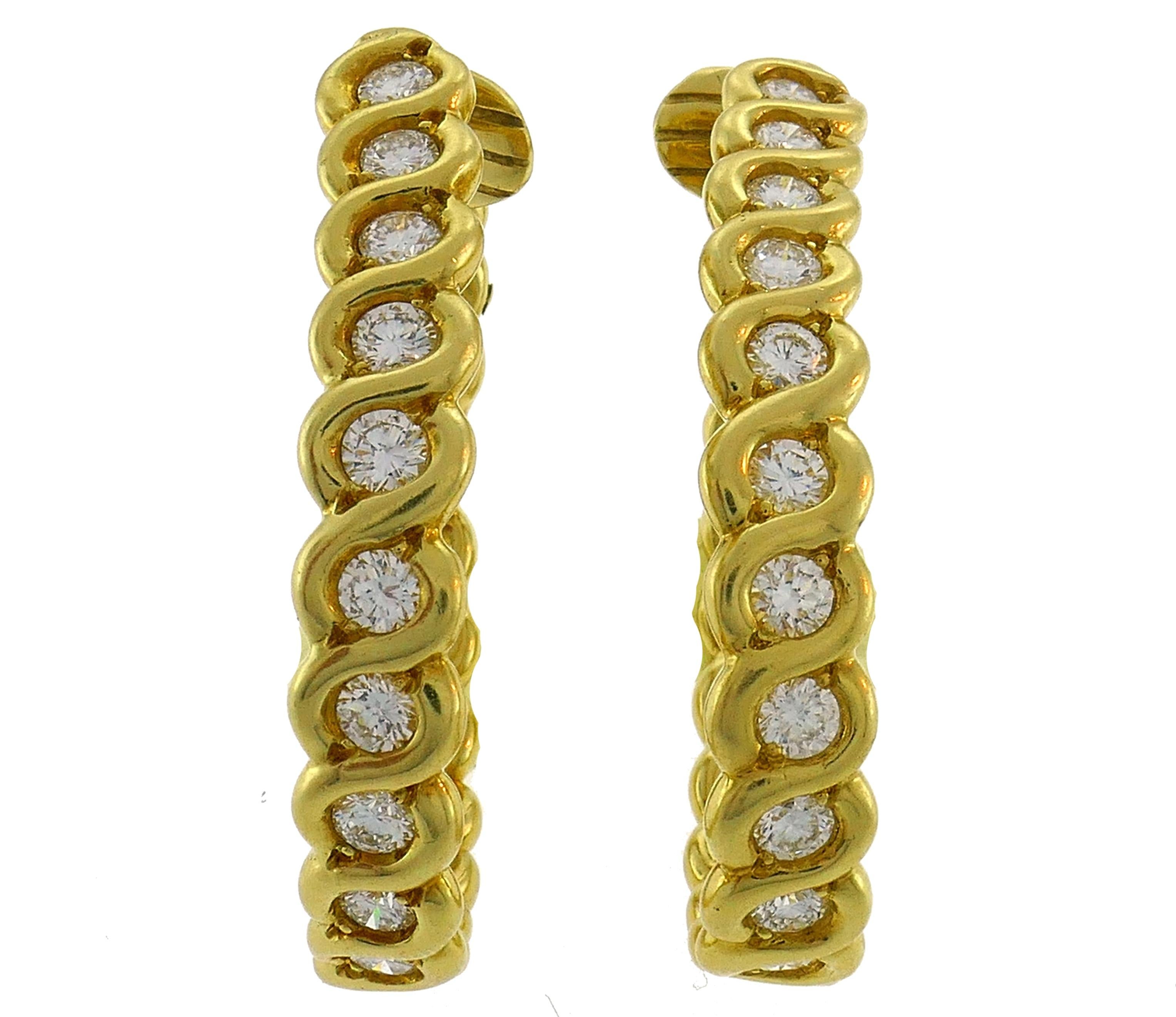 A pair of hoop earrings created in France in the 1980s. 
The earrings are made of 18 karat (stamped) yellow gold and set with round brilliant cut diamonds. Diamonds are G-H color, VS1 clarity, total weight approximately2.32 carats.
The earrings