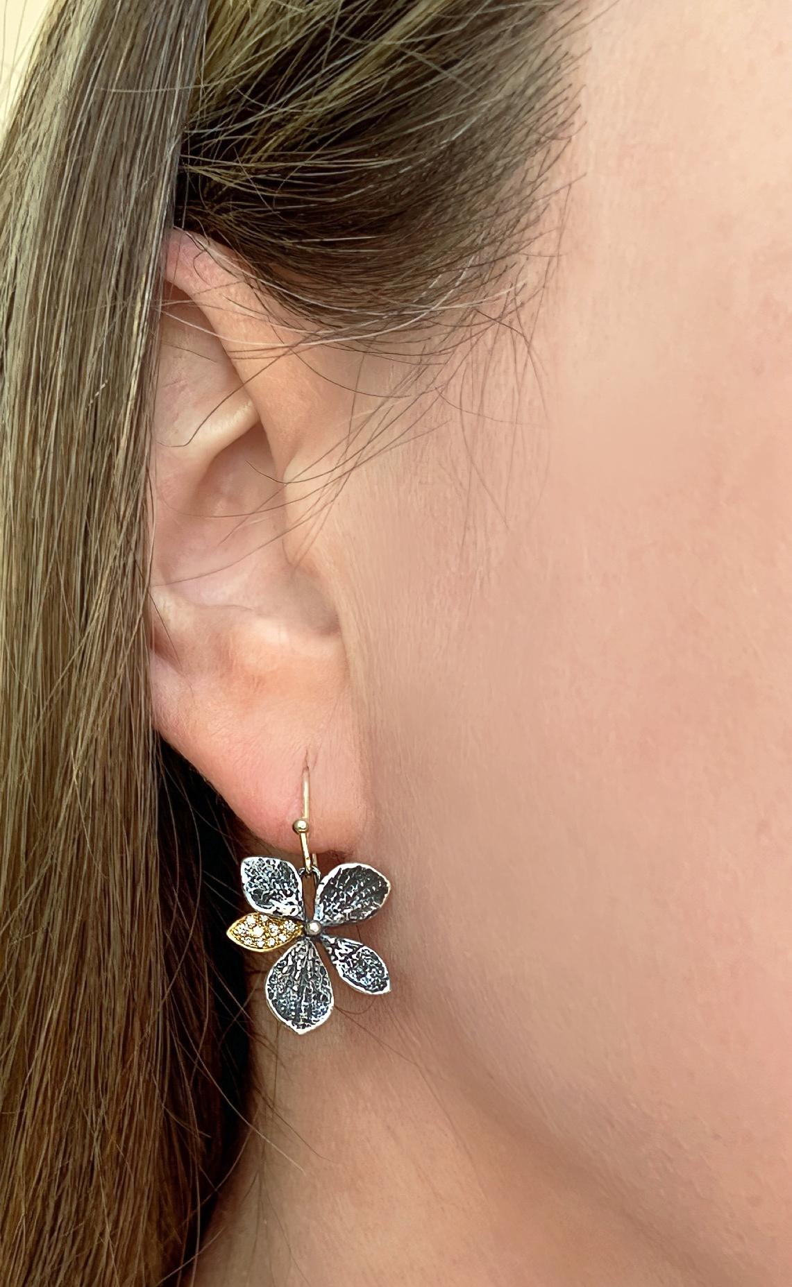Hydrangea Dangle Drop Earrings intricately handmade by world-renowned master jewelry artist John Iversen in oxidized sterling silver featuring two 18k yellow gold petals flush-set with round brilliant-cut diamonds and finished on 18k yellow gold ear