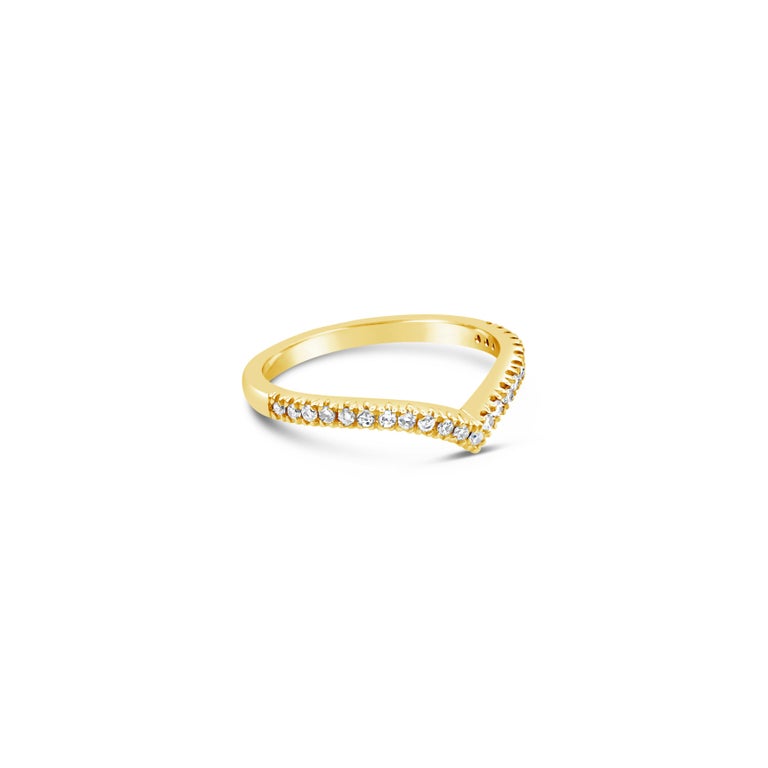 A modern wedding band style that can stack with an engagement ring. Set with 0.22 carats total of round brilliant diamonds along a V-shaped mounting. Made with 18K Yellow Gold Size 6.75 US 

Style available in different price ranges. Prices are