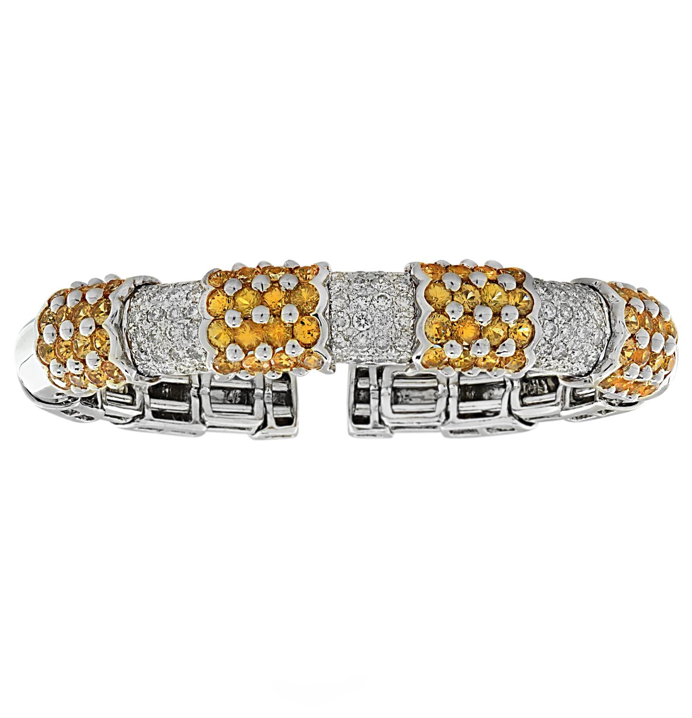 Stunning bangle bracelet crafted in 18 Karat white and yellow gold featuring 72 round brilliant cut diamonds weighing approximately 2 carats total, G color, VS clarity and 32 Yellow Sapphires weighing approximately 2 carats total. The diamonds are