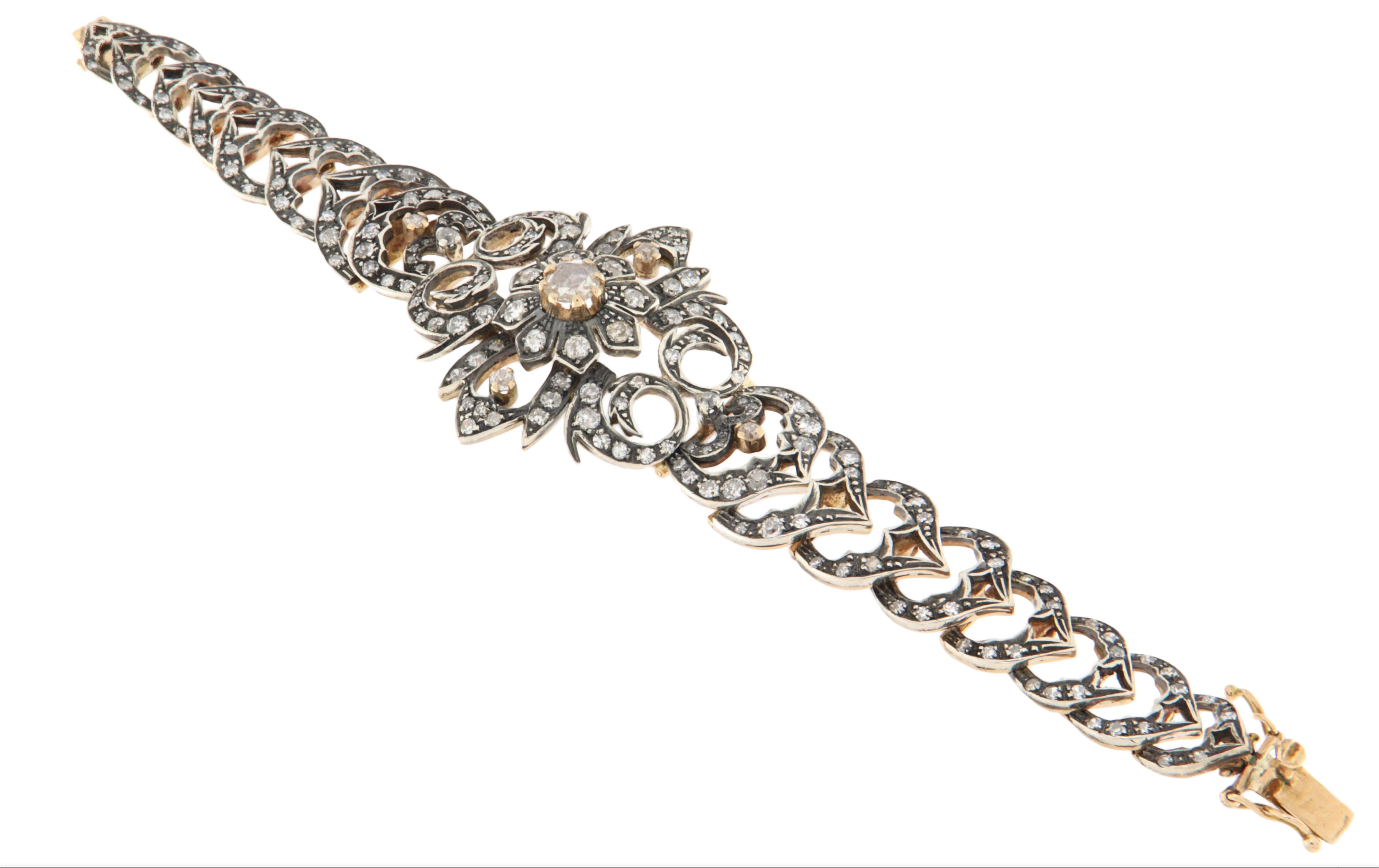 Impresionante pulsera vintage de oro amarillo de 14 quilates y 800 milésimas  de plata, bellamente adornada con diamantes talla brillante y un diamante talla rosa central. Esta refinada pieza encarna la elegancia clásica y muestra la maestría
