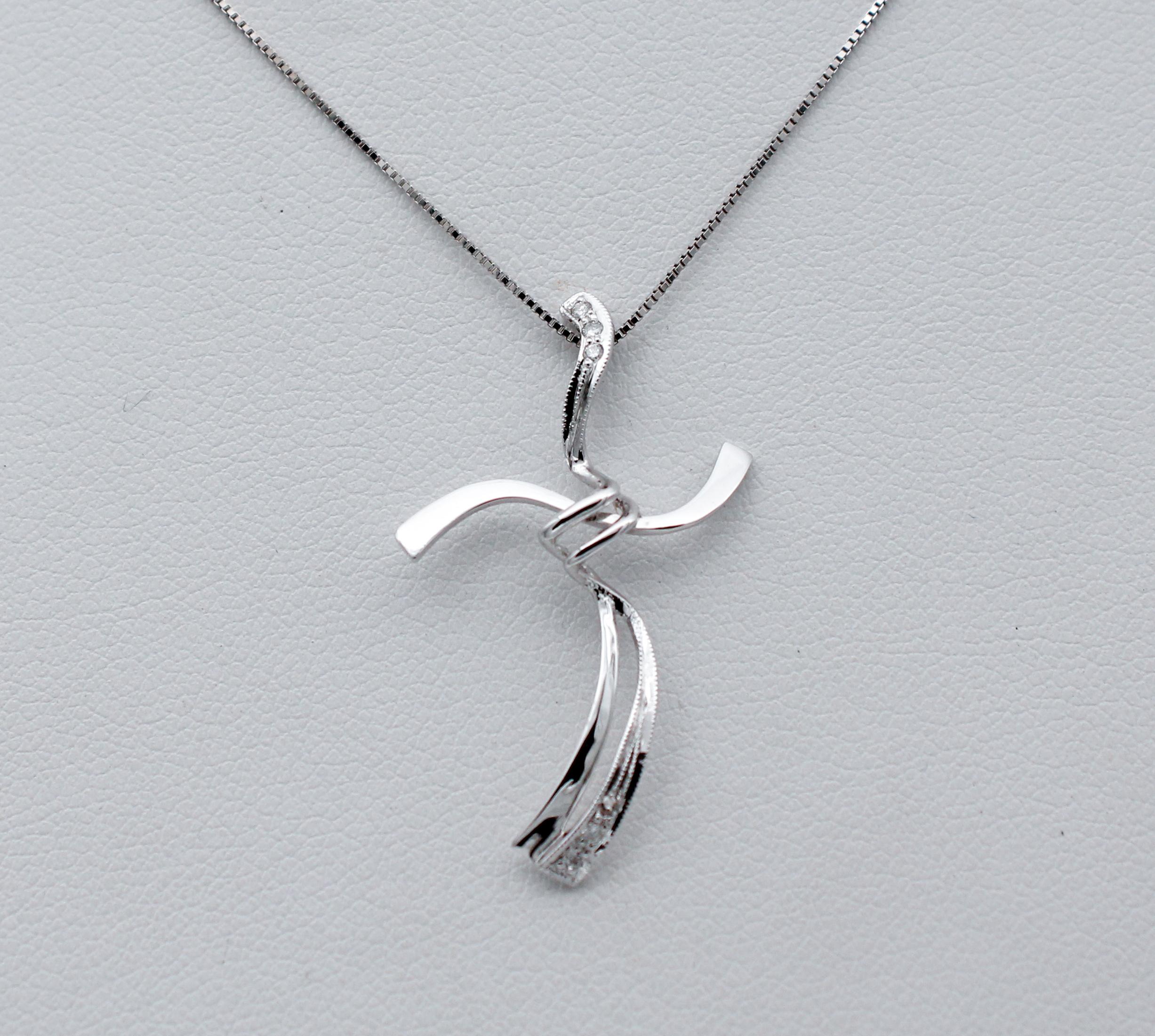 Beautiful  stylized cross shape pendant necklace realized in 18Kt white gold studded with little diamonds. The chain is included.
Diamonds 0.05 ct
Total Weight 2.20 gr
RF     G     GGRI
RK.AGOE85
Dimensions Pendant 3.1 cm x 2 cm
Lenght Necklace 45