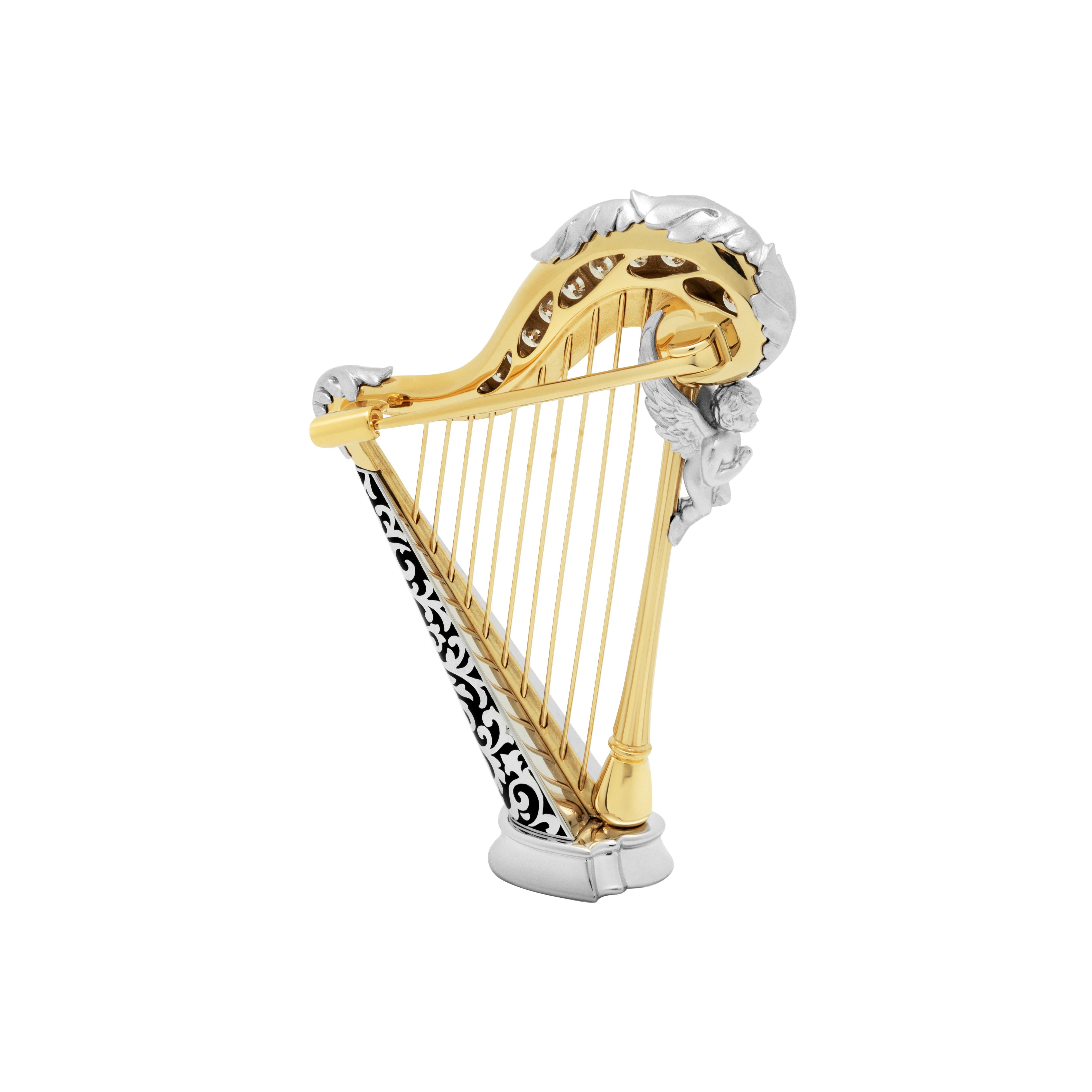 Diamonds 18 Karat White Yellow Gold Harp Brooch
Harps were widely used in the ancient Mediterranean and Middle East, although rare in Greece and Rome; depictions survive from Egypt and Mesopotamia from about 3000 BCE. 
Thanks to its “universal