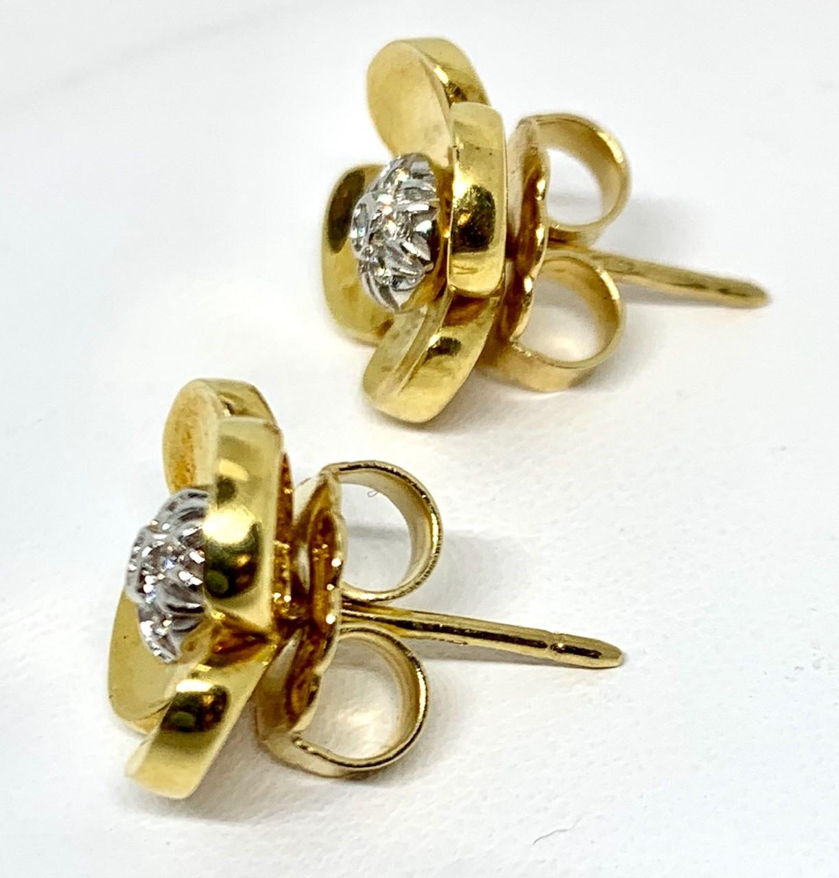 Positively blooming! These pretty floral earrings are a modern, yet classic, timeless design.  Fourteen round brilliant cut diamonds (.07 carats total) add a little sparkle.  Made of 18k yellow and white gold with ear posts and large backs. Every