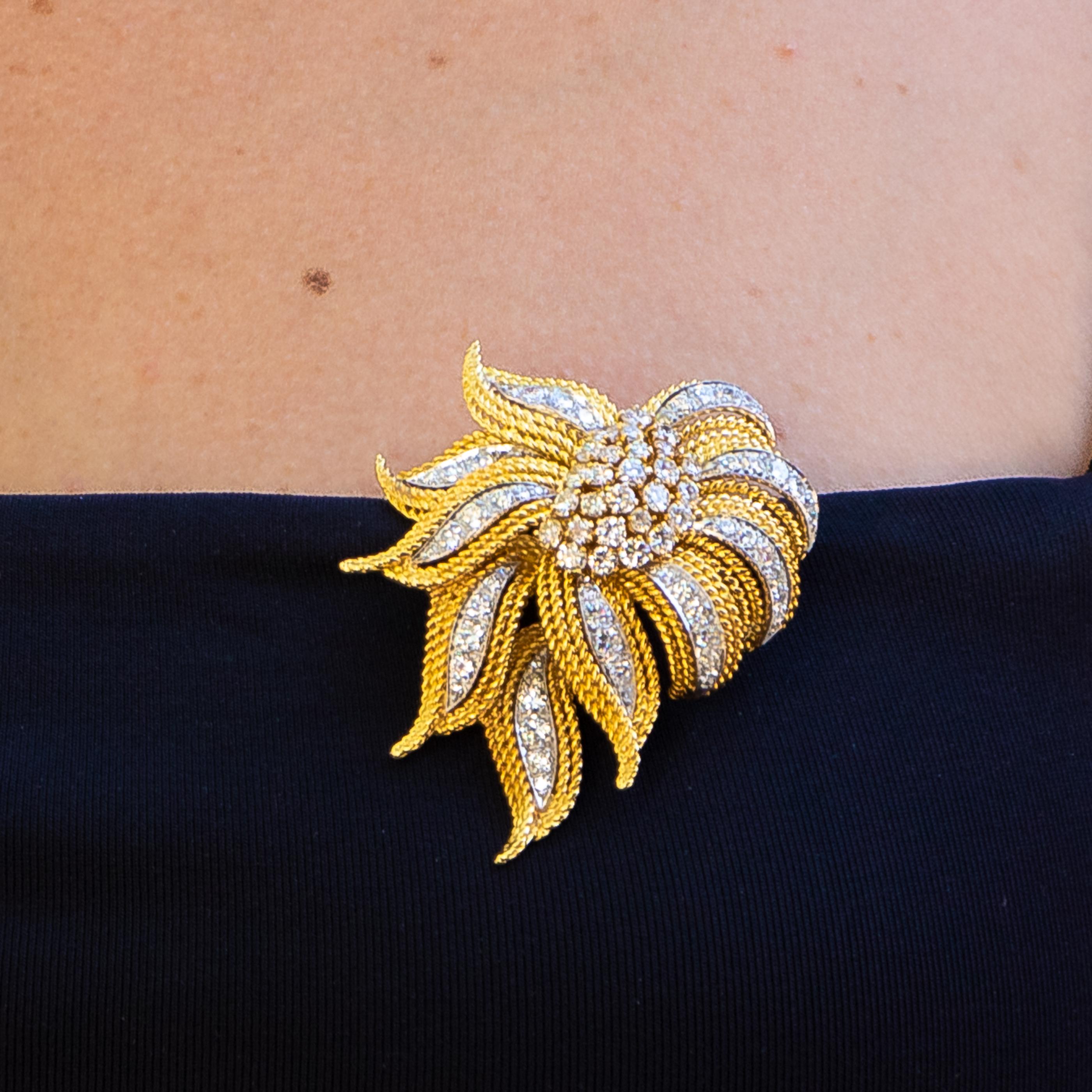 Beautiful hand made brooch with over 5 carats of diamonds on 18K gold and platinum. This brooch adds a beautiful flash to any outfit, and will always be the star of the show. This brooch can also be worn as a pendant on your favorite chain.