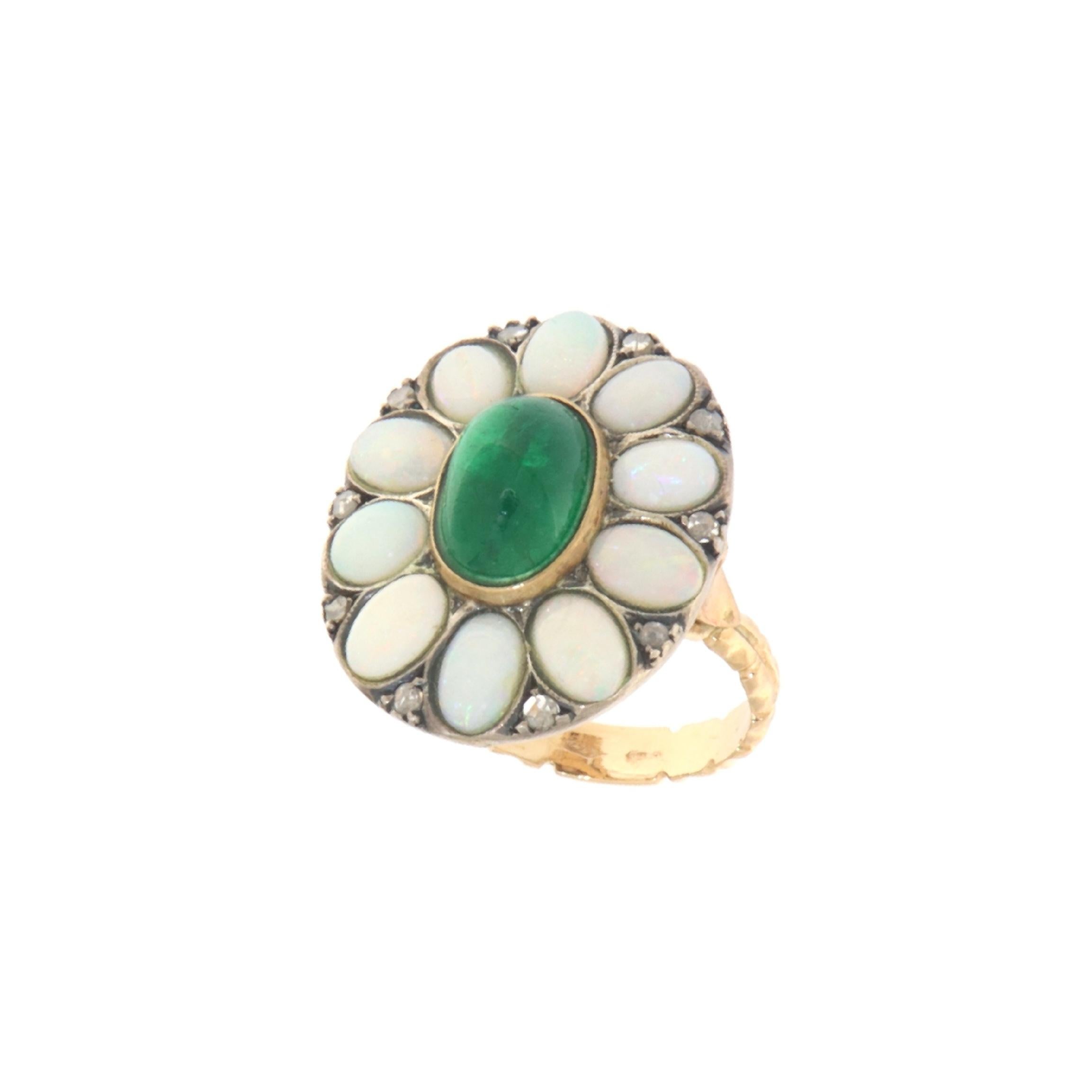 This alluring ring artfully combines 14-karat yellow gold and sterling silver, creating a piece that balances classic elegance with intricate detailing. It features a collection of antique-cut diamonds and Australian opals arranged in a charming