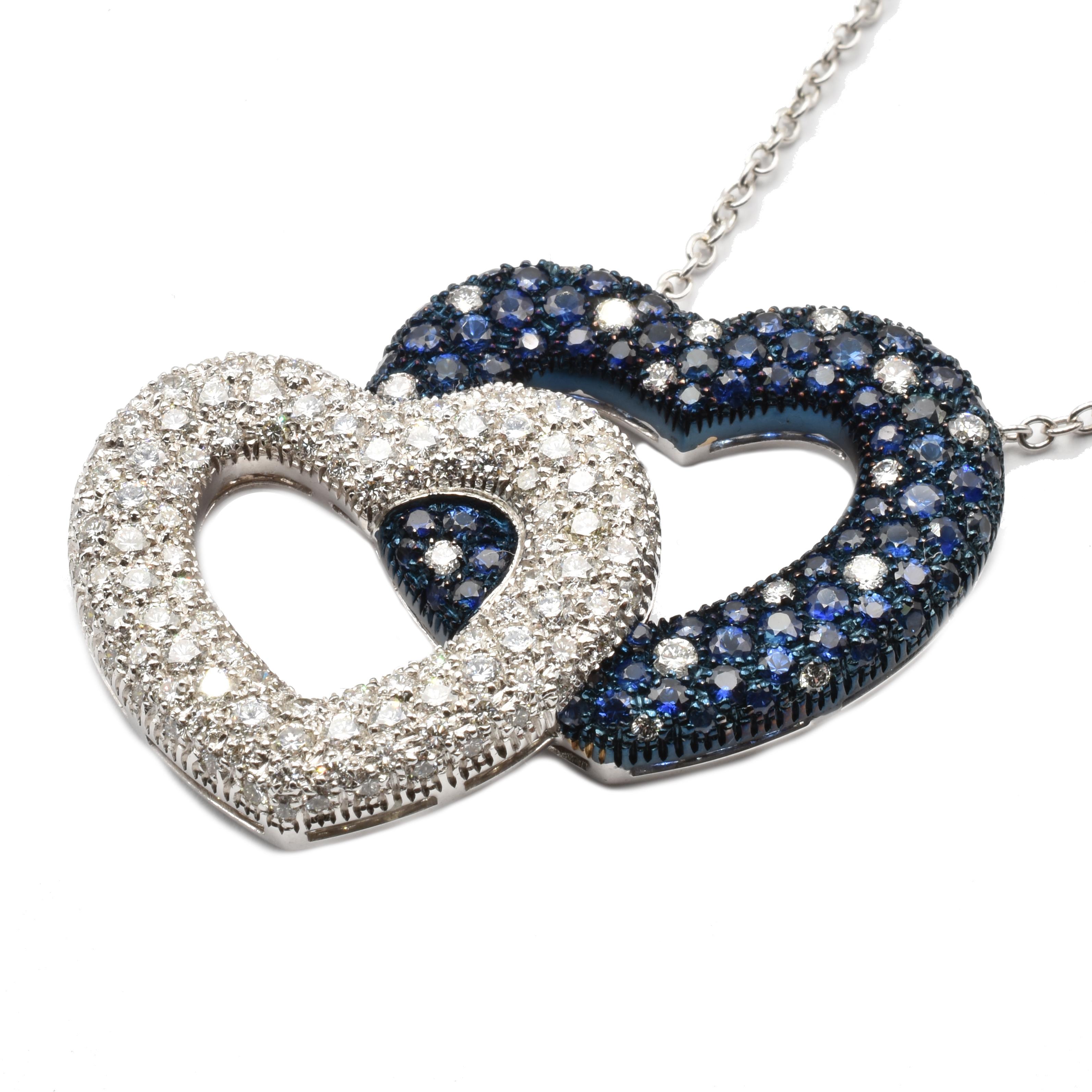 18Kt White Gold Double Heart Pendant Necklace with Diamonds and Sapphires.
Handmade in Italy in Our Atelier in Valenza (AL).
French Settings. Blue Rodhium on Sapphires Setting.
18Kt Gold g 21.20
G Color Vs Clarity White Diamonds ct 2.85
Sapphires ct