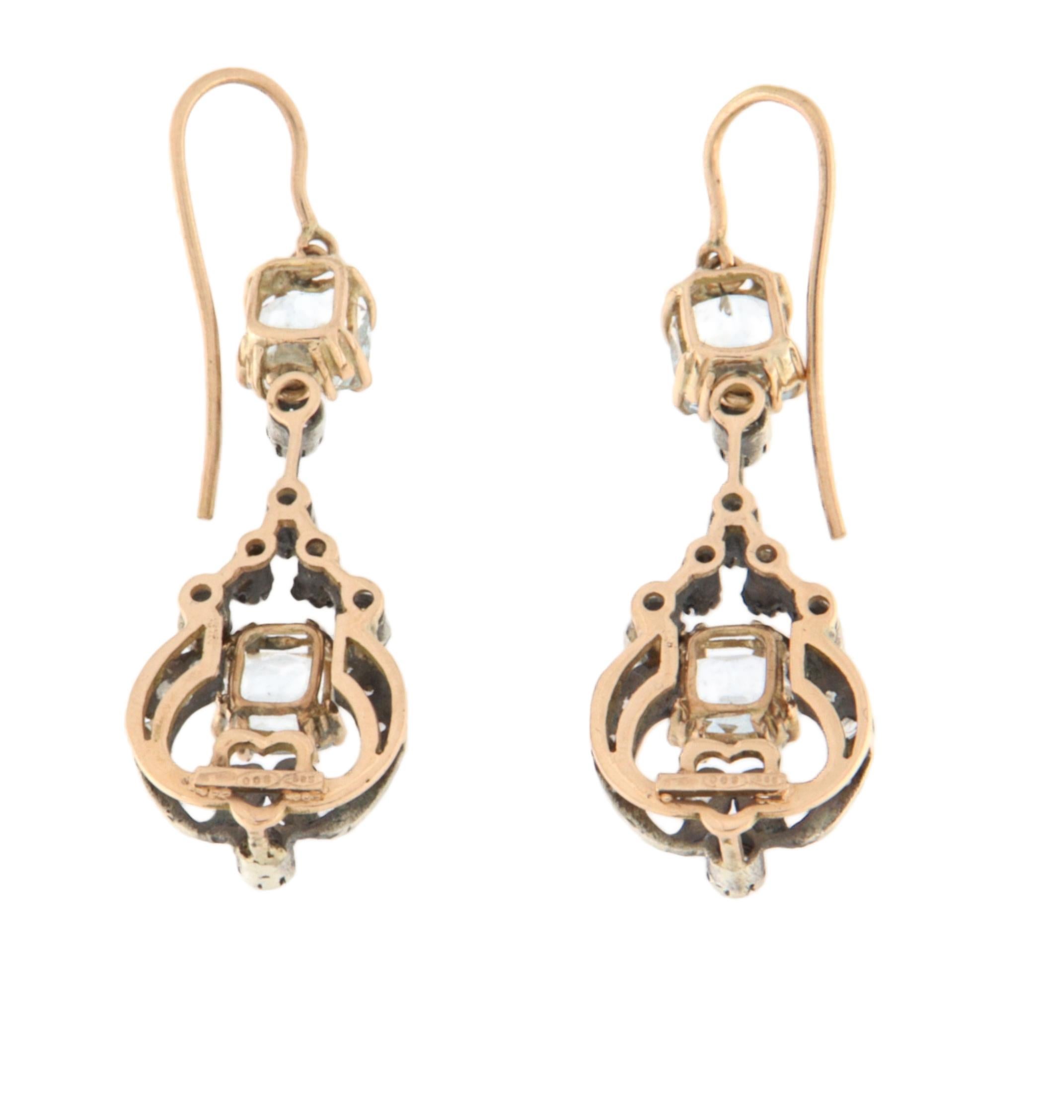Prächtige Ohrhänger aus einer raffinierten Kombination von 14K Gelbgold und 800er Silber, perfekt für alle, die ein zeitloses und elegantes Schmuckstück suchen. Die Fassung aus Gelbgold verleiht Wärme und Kostbarkeit, während das