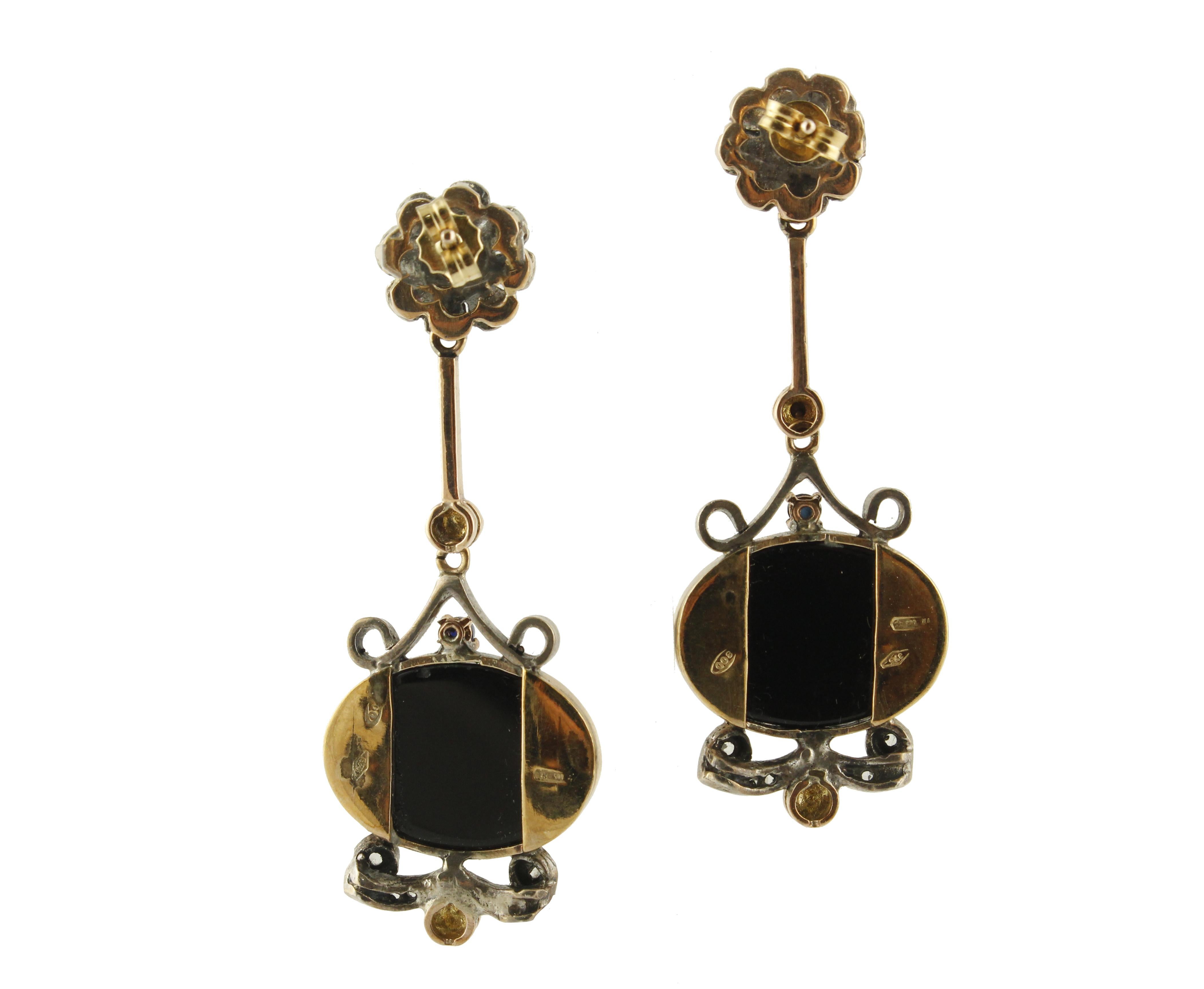 Fabulous earrings in 9K rose gold and silver structure composed of diamonds and blues sapphires flower at the top and onyx plates and blue sapphires and diamonds detailes in the final part
Diamonds 0.21 ct 
Blue Sapphires 0.91 ct 
Onyx Plates 3.4 g 