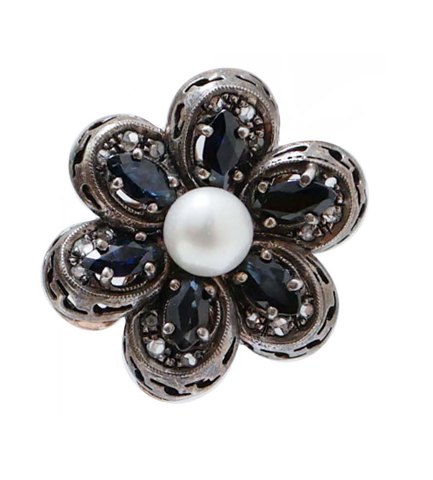 Wonderful flower shape earrings in 14K rose gold and silver structure composed of small white pearls in the center surrounded by marquise cut intense color blue sapphires, studded around by rose cut diamonds.
These earrings are totally handmade by