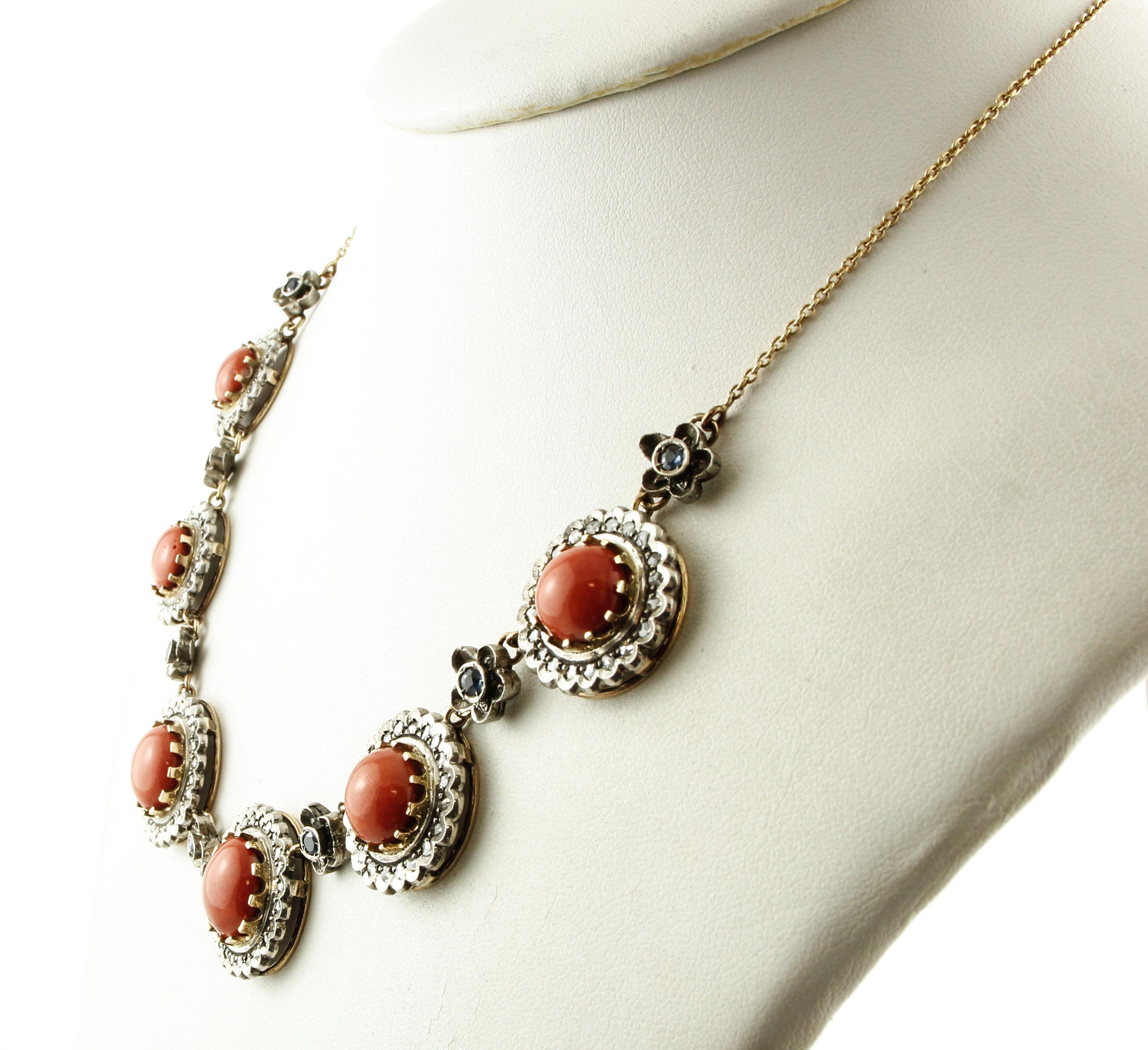 Gorgeous link necklace realized in 14K rose gold and silver composed of 6 parts, mounted each one with red rubrum coral in the center, surrounded by diamonds crown and link thanks to blue sapphires, rose gold and silver flowers.
Diamonds 1.39