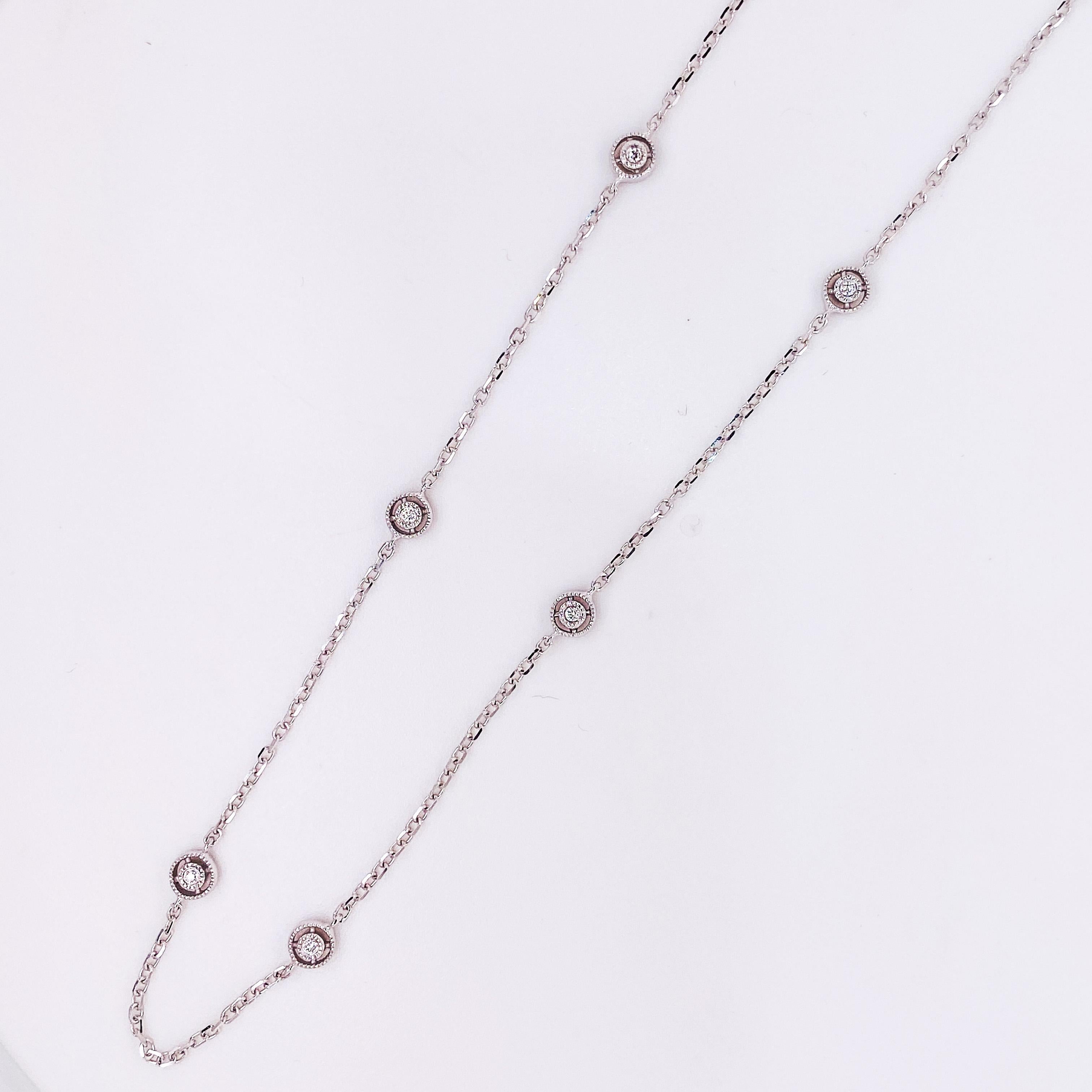 This diamonds by the yard necklace has 10 diamonds that are spaced out on a cable chain. The 18-inch chain has a unique design with a satellite design around each diamond. There is a beaded design around each diamond. The entire necklace is 14 karat