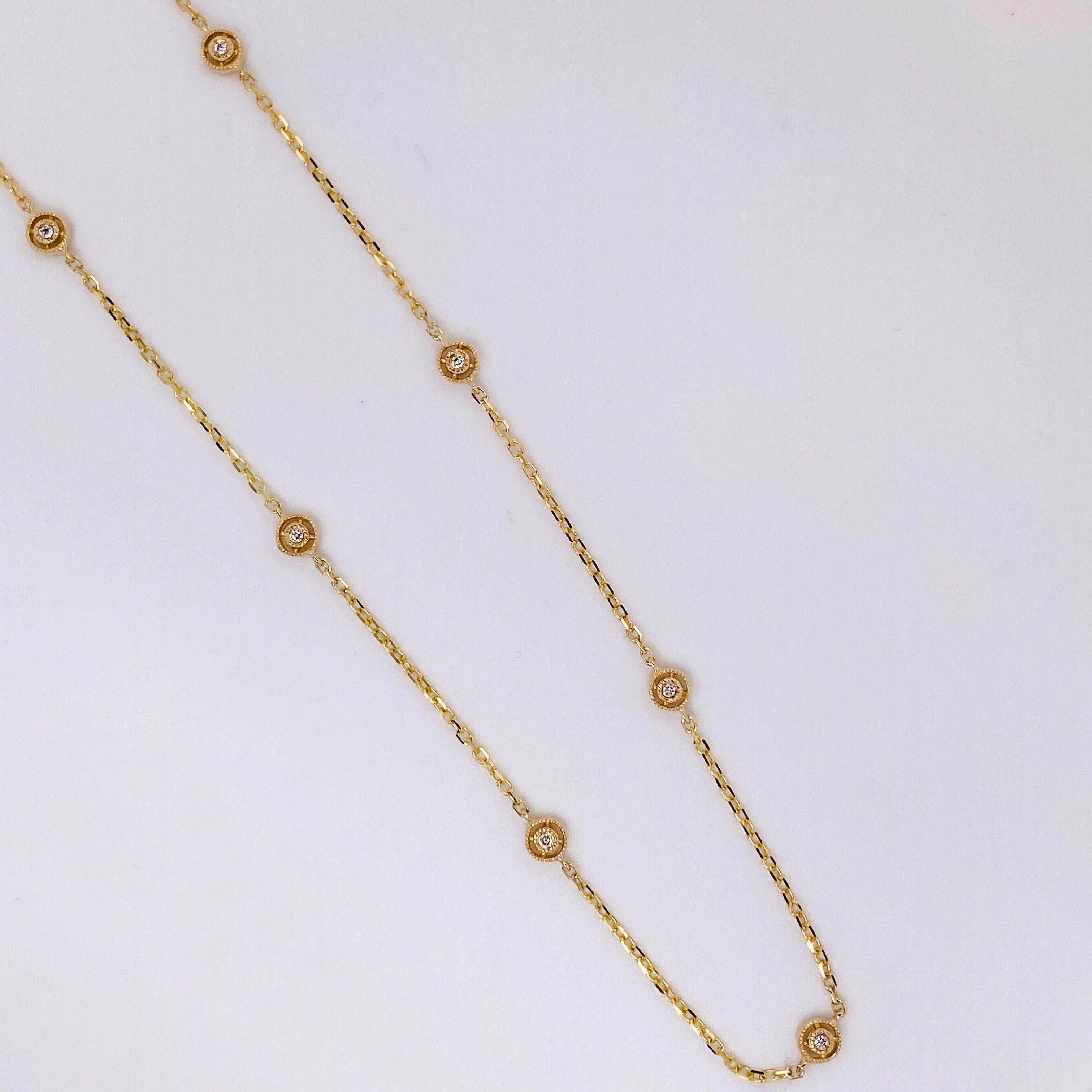 This diamonds by the yard necklace has 7 diamonds that are spaced out on a cable chain. The 18 inch chain has a unique design with a satellite design around each diamond. There is a beaded design around each diamond. The entire necklace is 14 karat