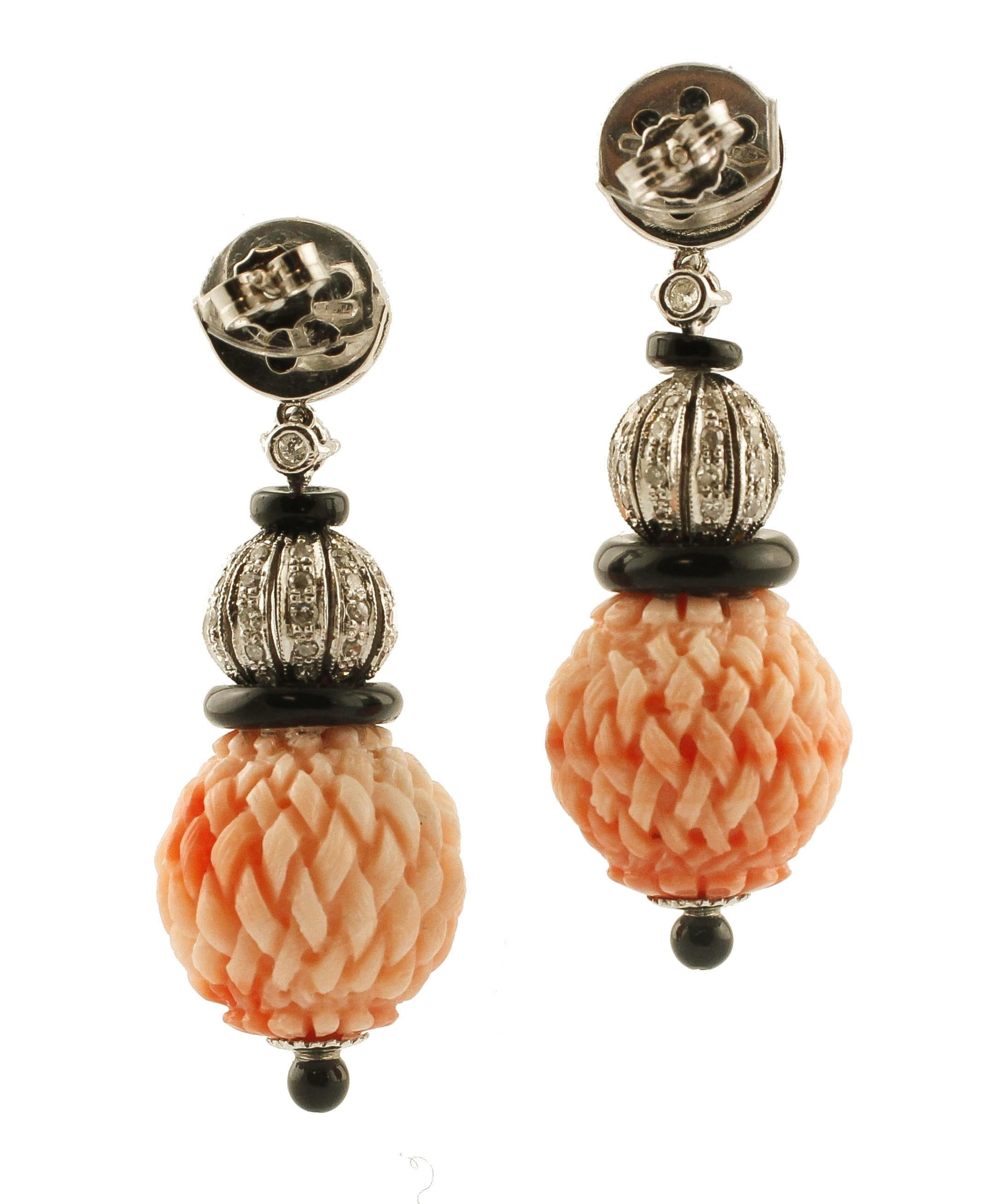 Gorgeous pair of earrings realized in 14k white gold structure and made of 3 sections: the upper part is formed by black agate base studded with a central diamond; the middle part is formed by sphere details in white gold studded with diamonds; the