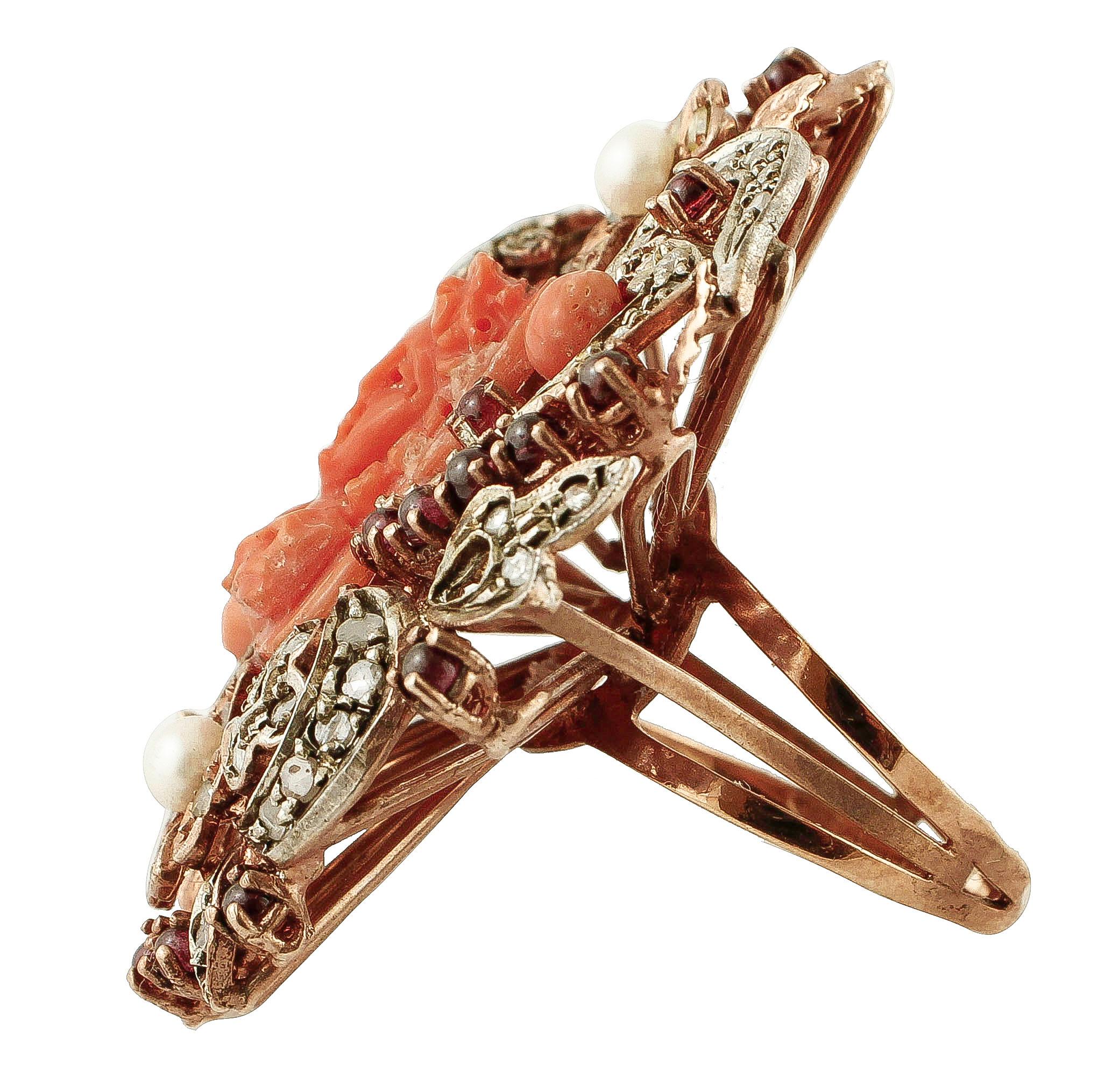 Fantastic retrò ring in 9K rose gold and silver structure (flower and leaves theme) mounted with an amazing rectangular shape red engraved coral in the center, adorned around by 2 little coral, 2 little pearls, little diamonds, little yellow hard