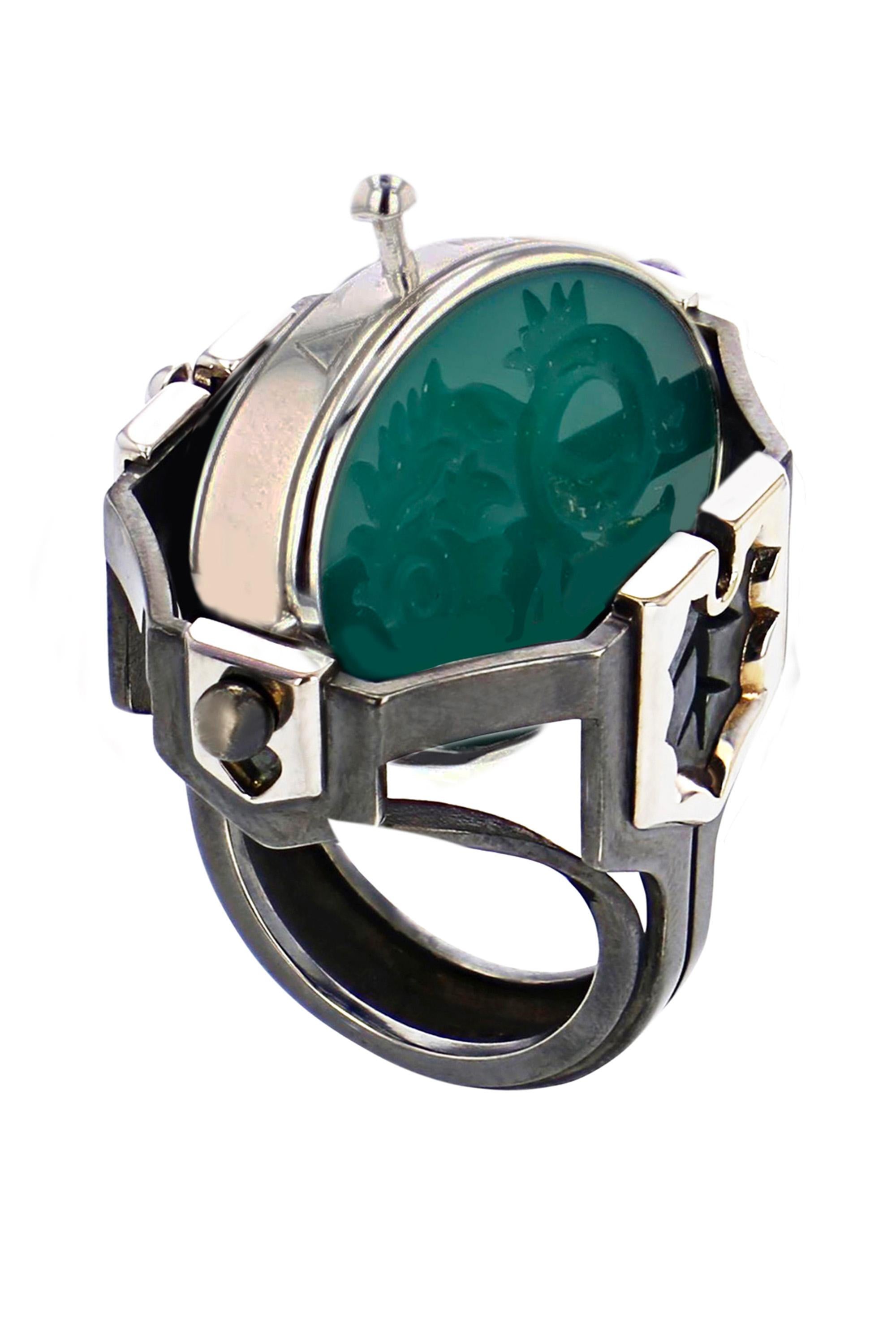 White gold and distressed silver ring. Rotating medallion : on the gold side are engraved Water signs (Cancer, Scorpio, Pisces) and on the green agate, a fish.

Details:
Green Agate
3 Diamonds: 0.1 cts
18k White Gold: 18g
Distressed Silver: 11g
Made