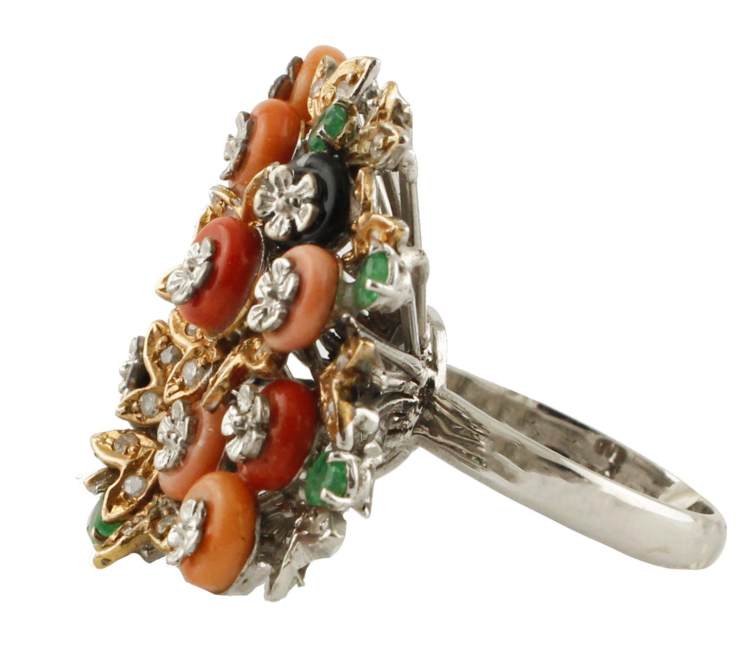 Fashion ring in 14K white gold structure mounted with rose gold leaved studded by diamonds, and adorned with emeralds, onyx hoops,and (pink, orange, red) coral hoops. All hoops have on them white gold little flowers.
Diamonds 0.34 ct
Emeralds 0.45