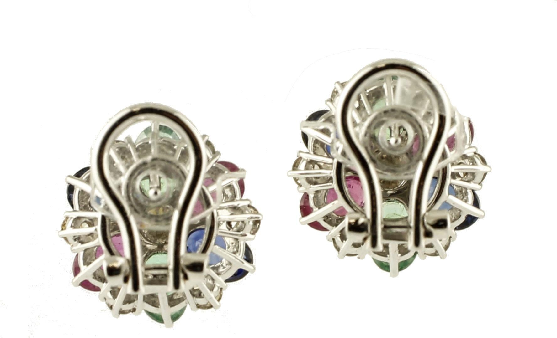 Gorgeous pair of stud earrings in 14k white gold structure setted with diamonds, emeralds, rubies and blue sapphires, 
These earrings are totally handmade by Italian master goldsmiths
Lateral Diamonds 0.9 ct
Central diamonds 0.92 ct
Rubies,
