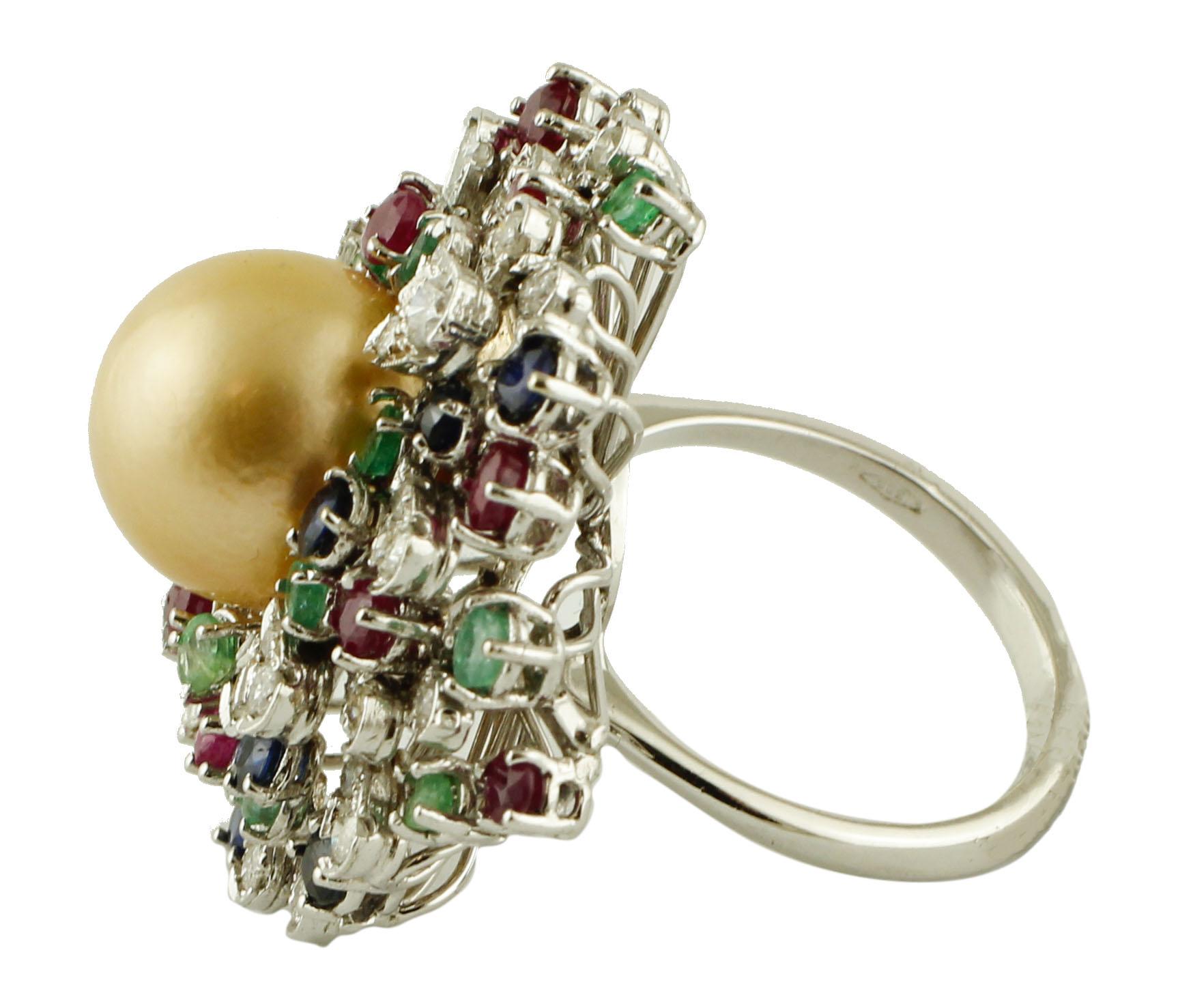 Beautiful cocktail ring in 14k white gold structure, mounted with a central south sea pearl (12mm), surrounded by a beautiful frame of diamonds, rubies, emeralds and blue sapphires. 
This ring is totally handmade by Italian master