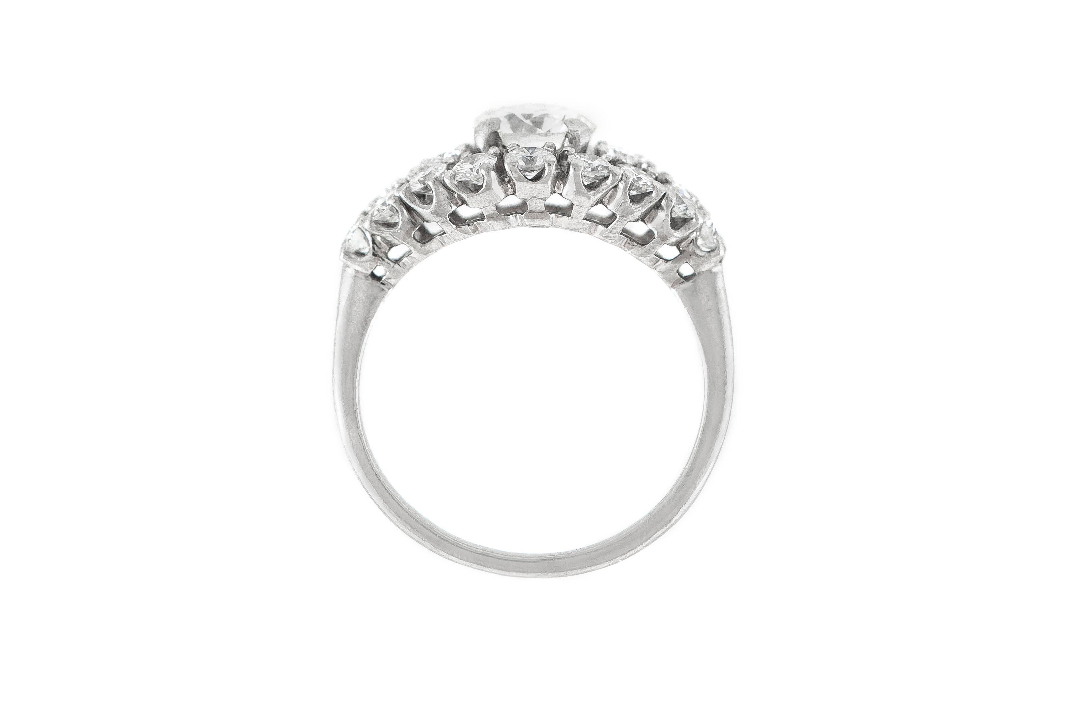 The ring is finely crafted in platinum with center diamond weighing approximately total of 1.00 carat. Color E-F , Clarity VS .
The round diamonds weighing approximately total of 0.90 carat.